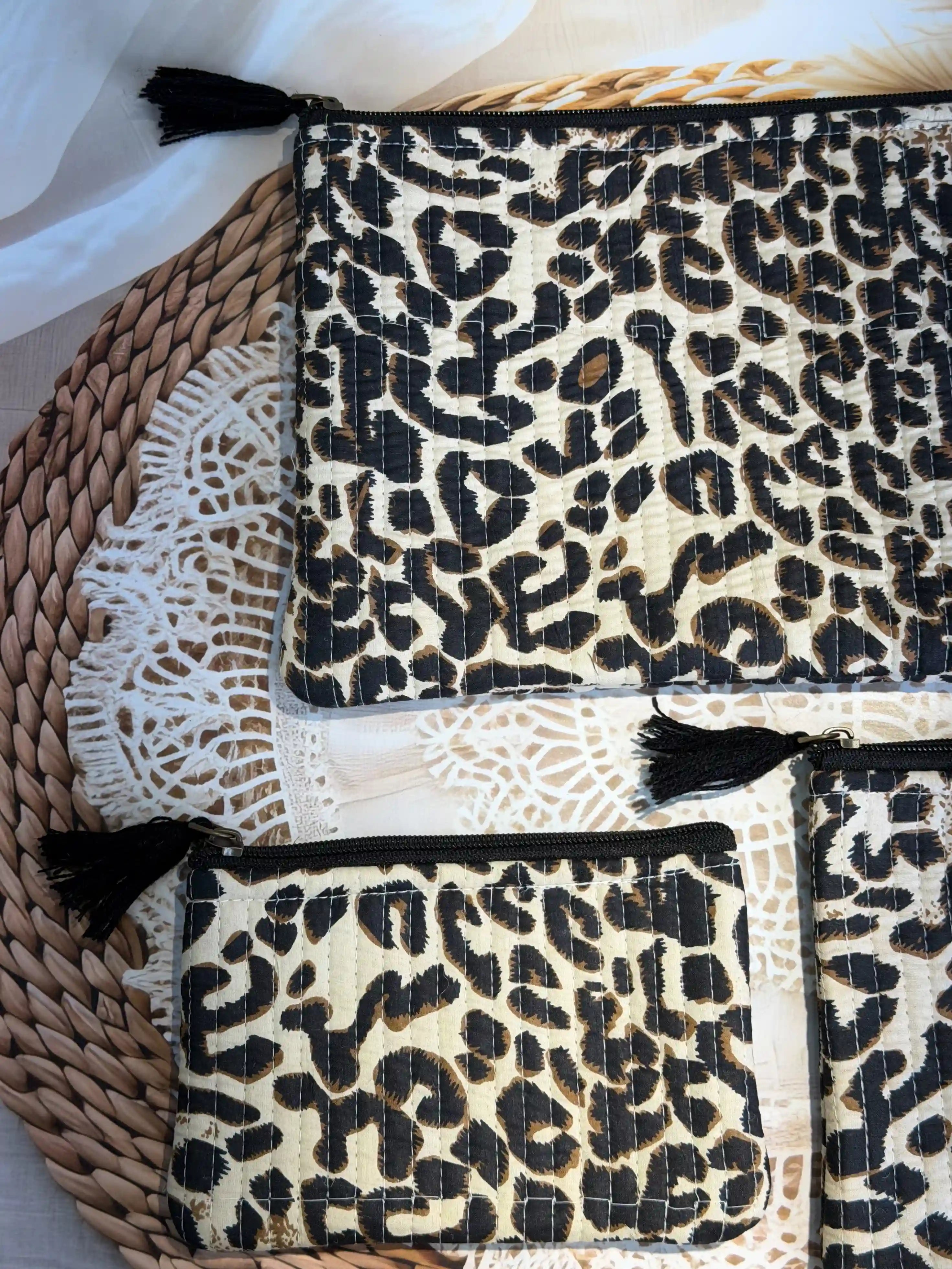 Beige quilted cotton flat pouch set with black leopard print hand block design, three-piece lightweight zipper organizer for travel and daily essentials.
