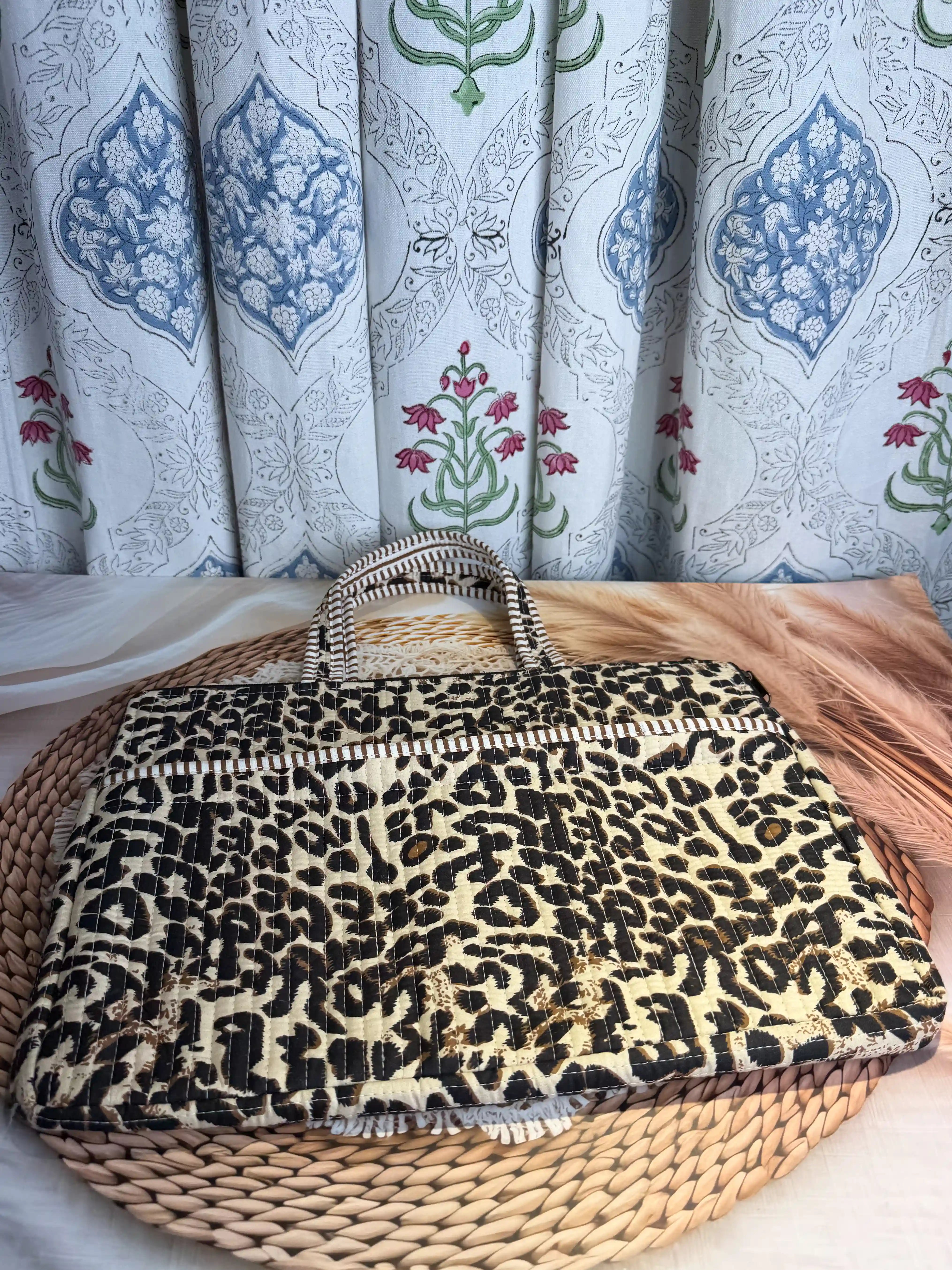 Beige quilted cotton laptop bag with leopard print hand block design and cream striped borders, animal print padded laptop sleeve