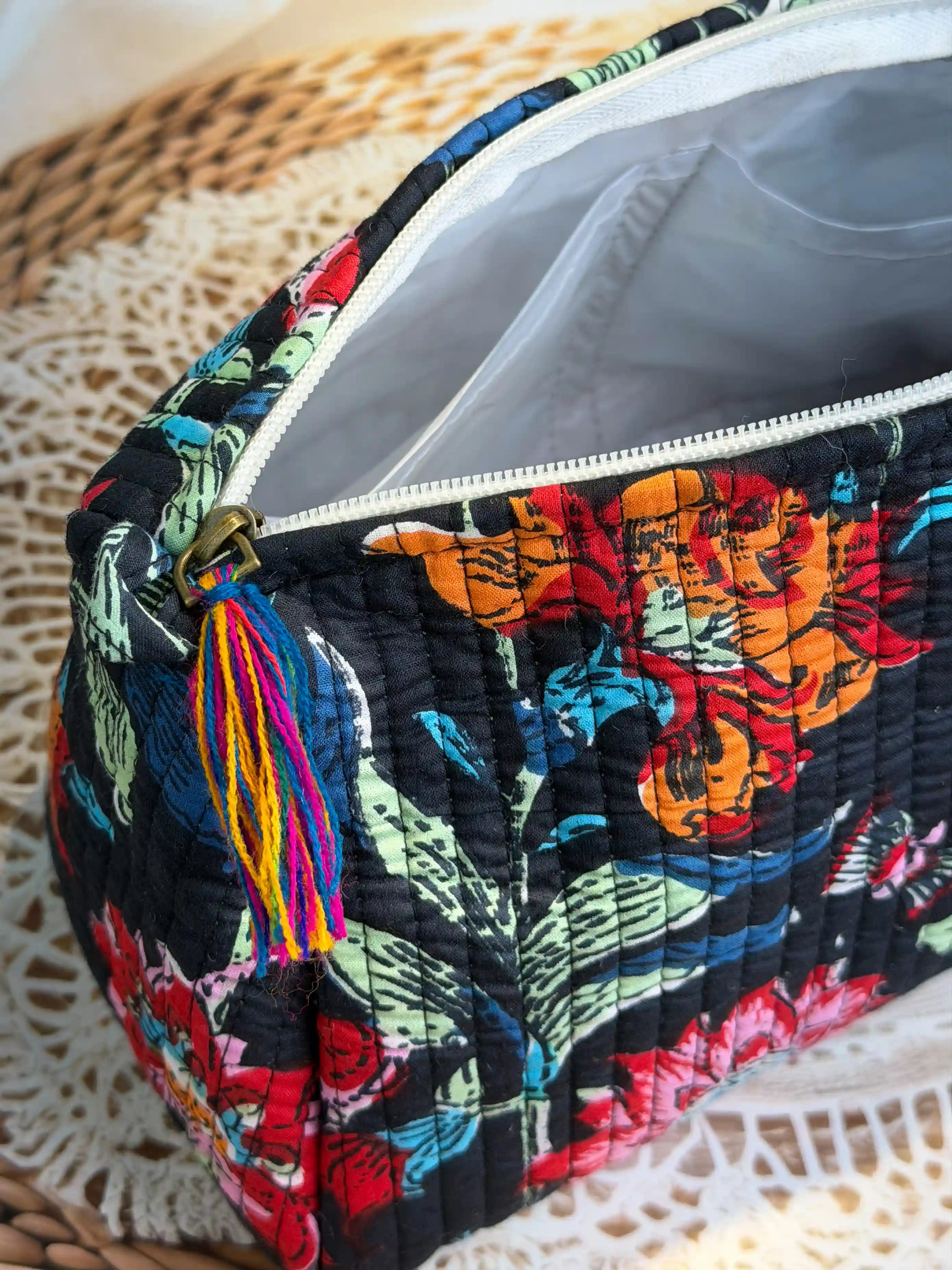 Black quilted cotton toiletry pouch set with vibrant red and orange multicolor floral hand block print, three-piece handmade travel organizer.