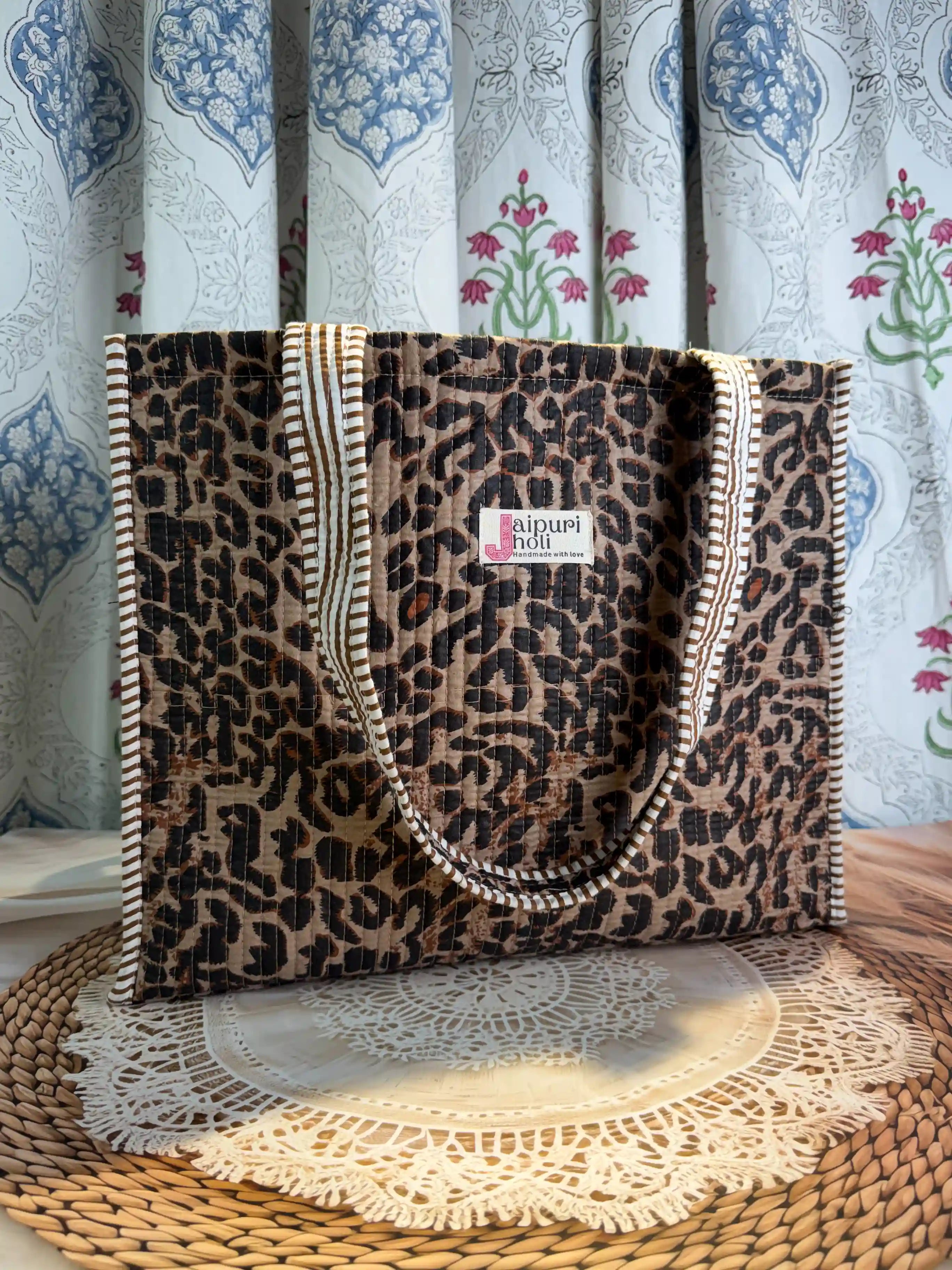 Black and brown quilted cotton open mini tote with leopard hand block pattern, lightweight animal print mini bag for daily essentials.