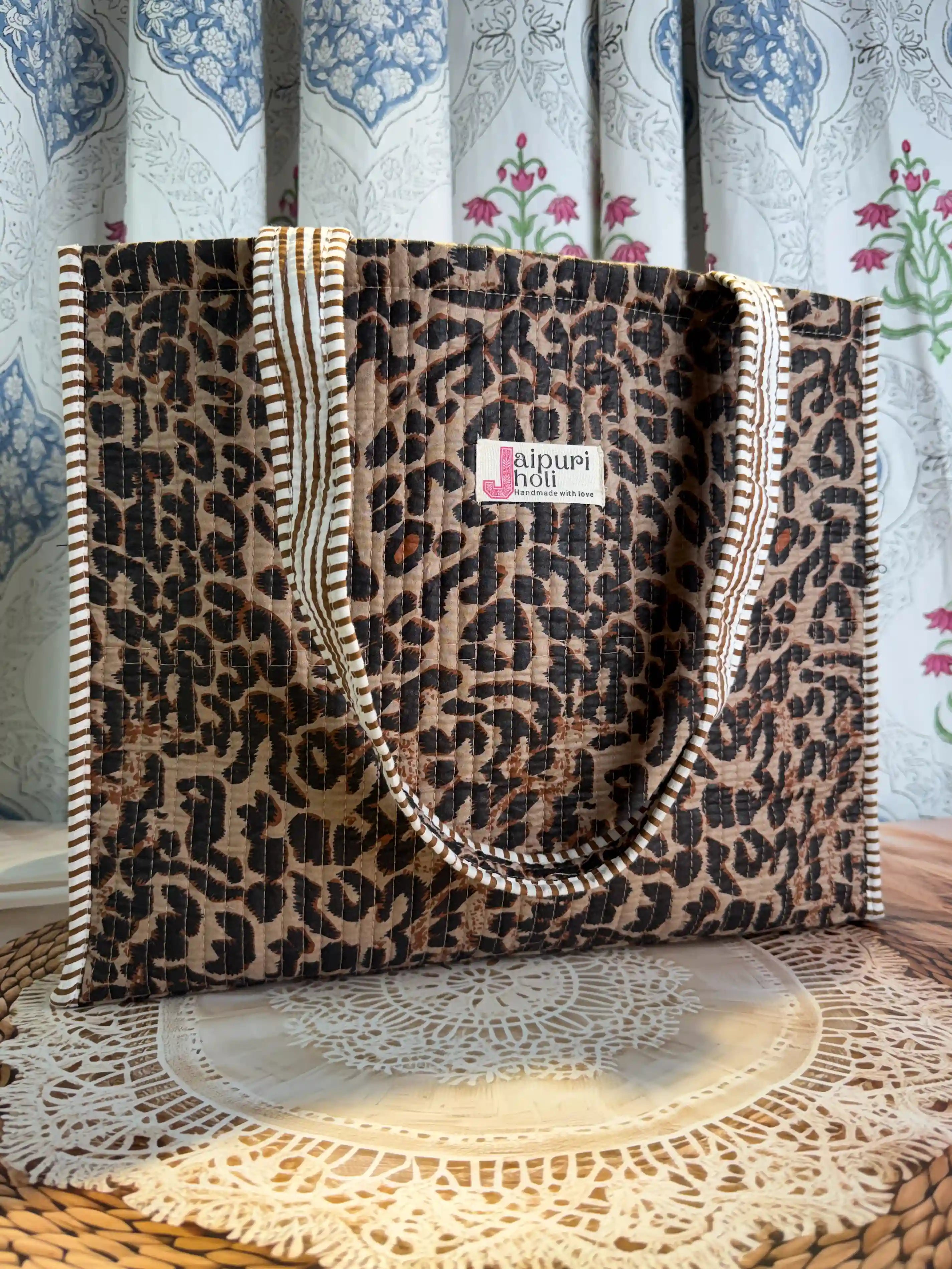 Black and brown quilted cotton tote bag with leopard print hand block pattern and zip, lightweight animal print tote for daily essentials.