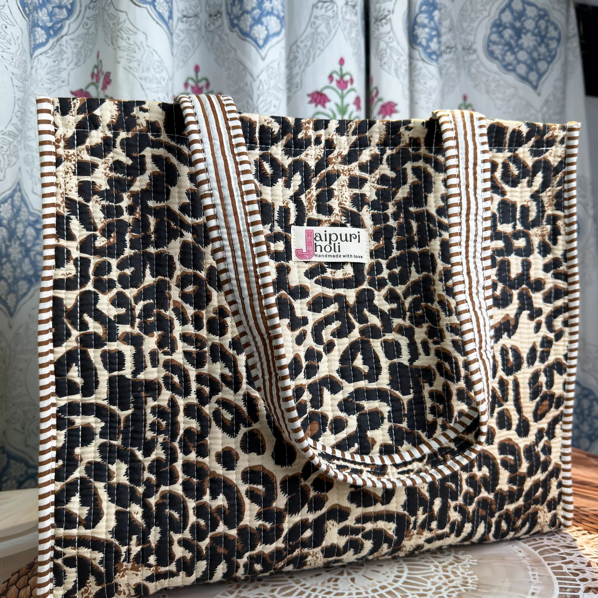 Black and cream quilted cotton tote bag with leopard print hand block pattern and zip, animal print shoulder bag for everyday use.