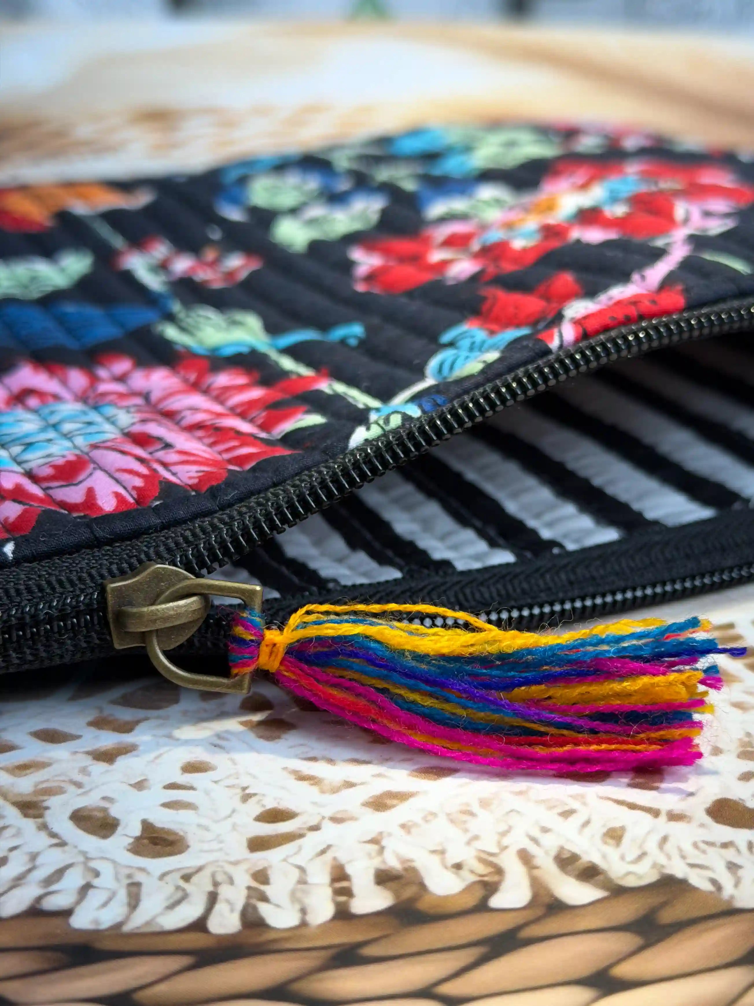 Black quilted cotton flat pouch set with red and orange multicolor floral hand block print, three-piece handcrafted zipper pouches for organization.