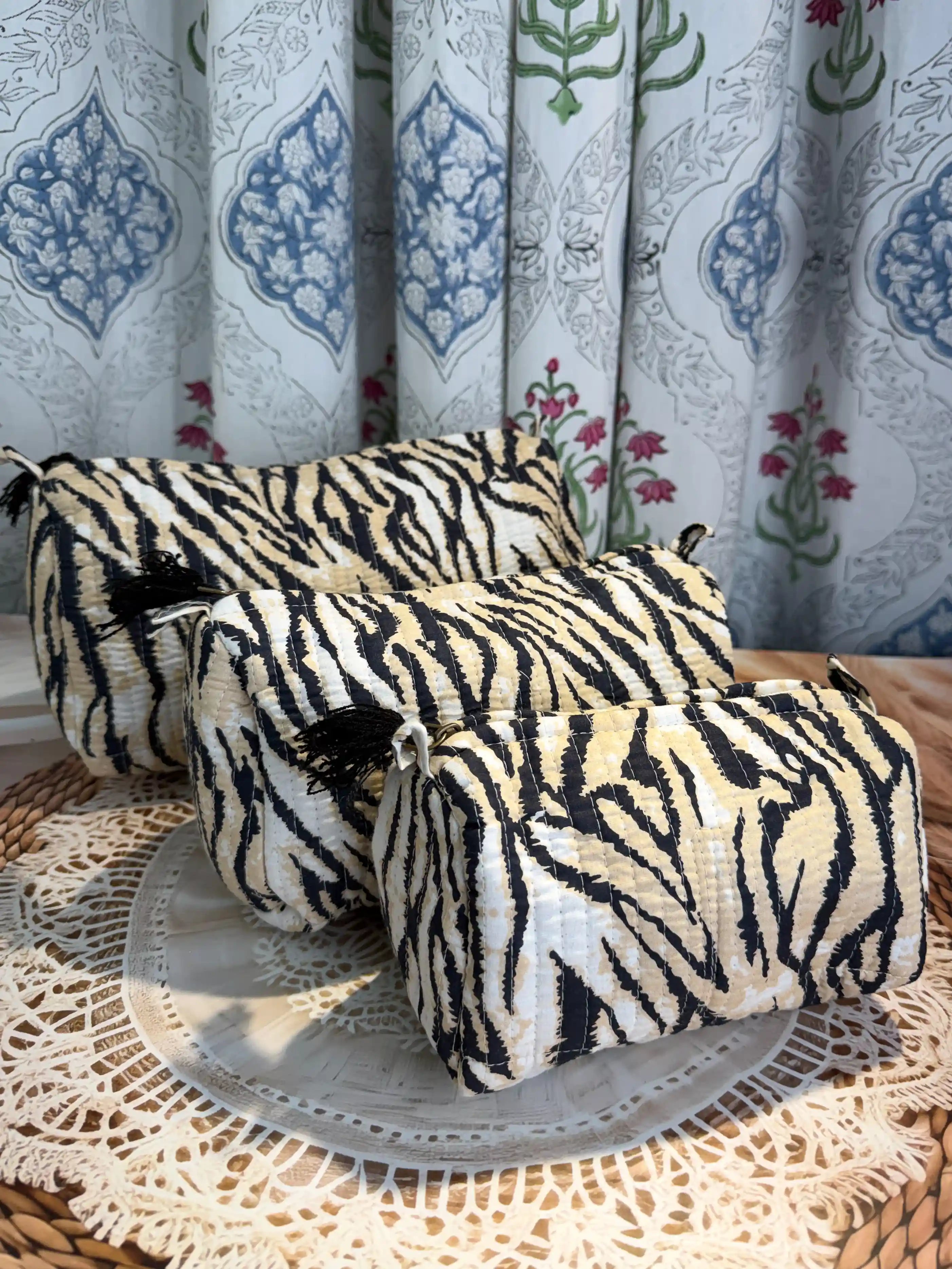 Black and white tiger stripe quilted cotton toiletry pouch set with hand block pattern, animal print three-piece lightweight organizer for bathroom essentials.