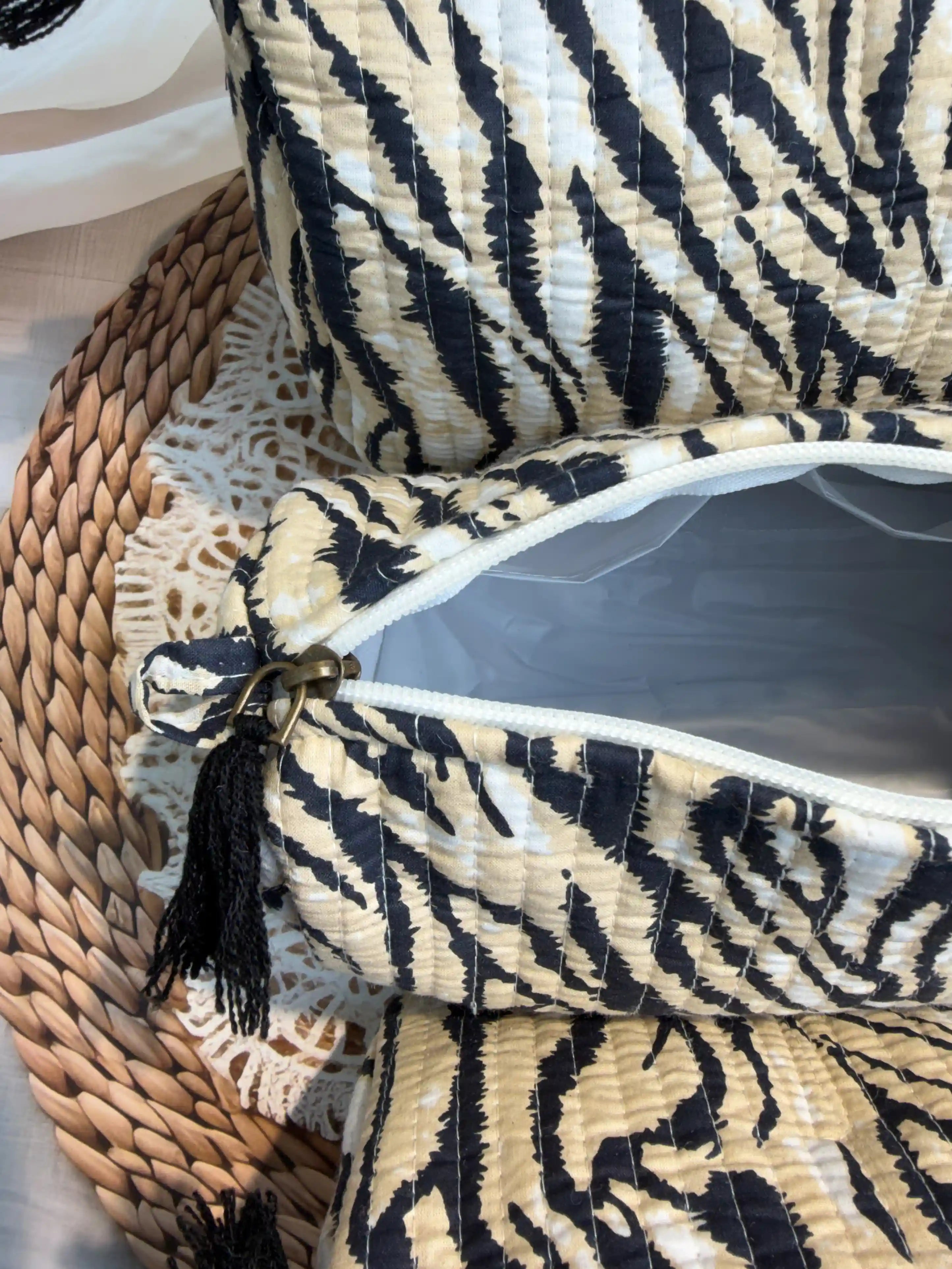 Black and white tiger stripe quilted cotton toiletry pouch set with hand block pattern, animal print three-piece lightweight organizer for bathroom essentials.