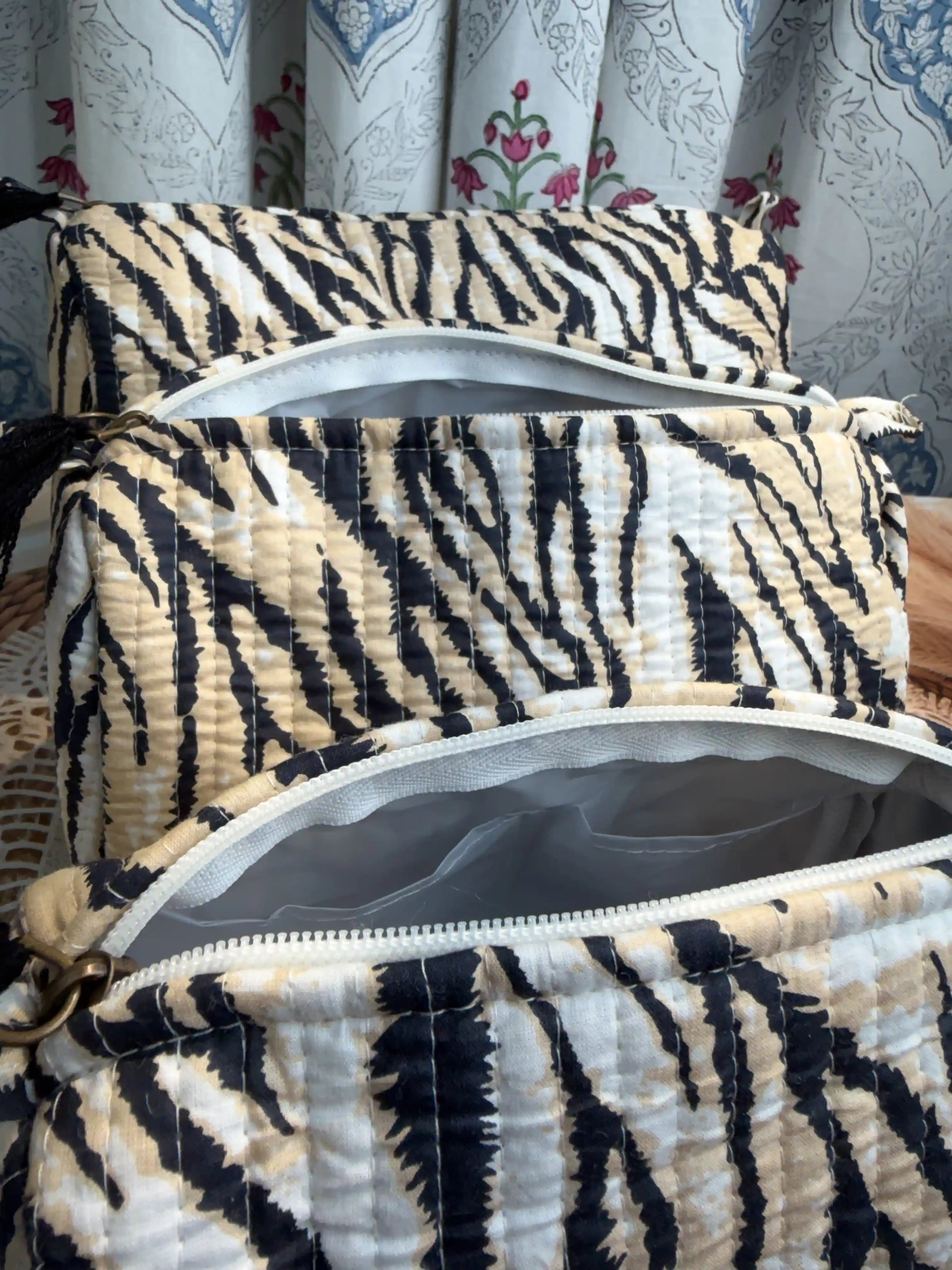 Black and white tiger stripe quilted cotton toiletry pouch set with hand block pattern, animal print three-piece lightweight organizer for bathroom essentials.