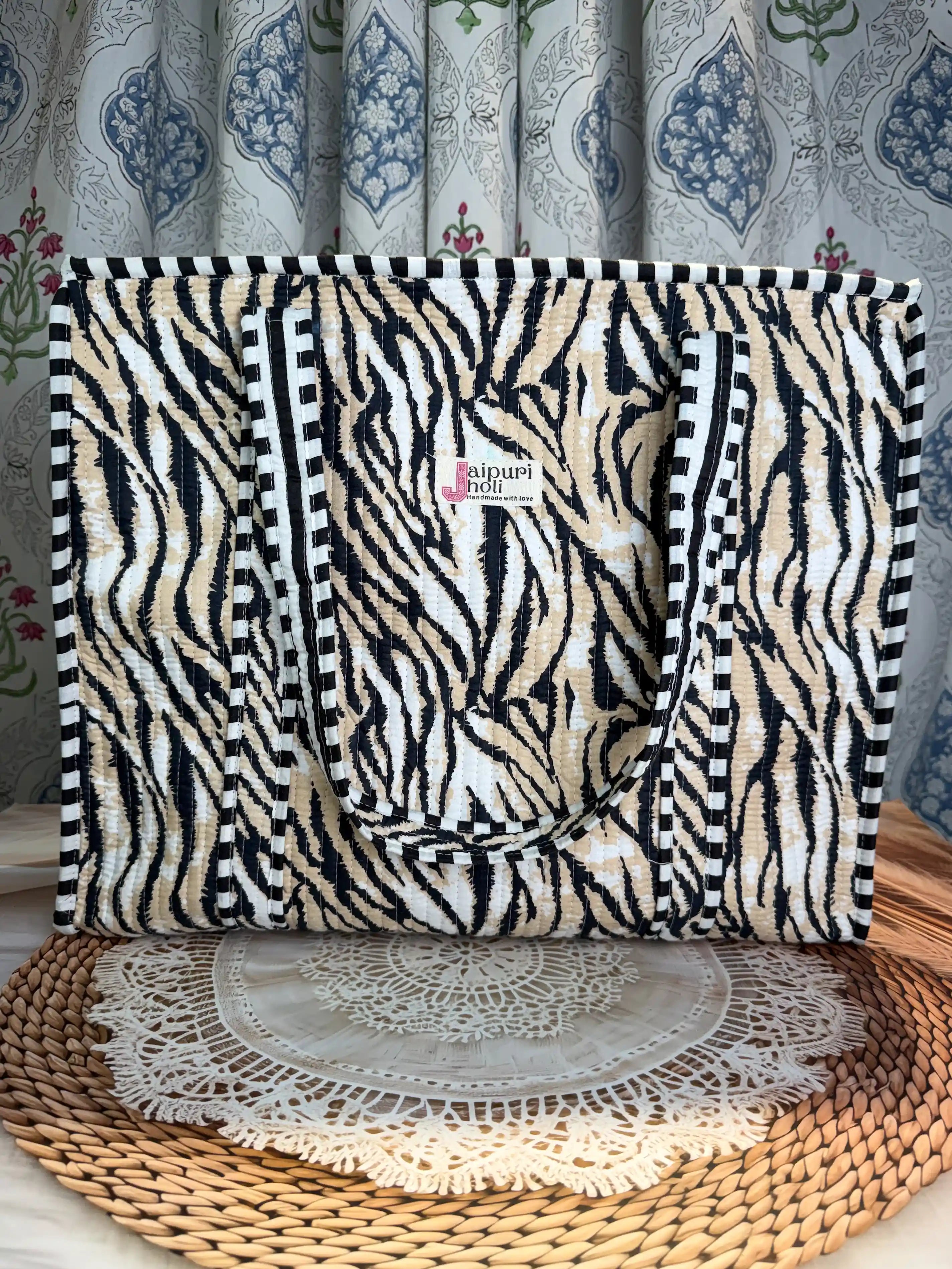 Black and white tiger stripe quilted cotton tote bag with hand block pattern and zip, striking animal print shoulder bag for everyday carry.