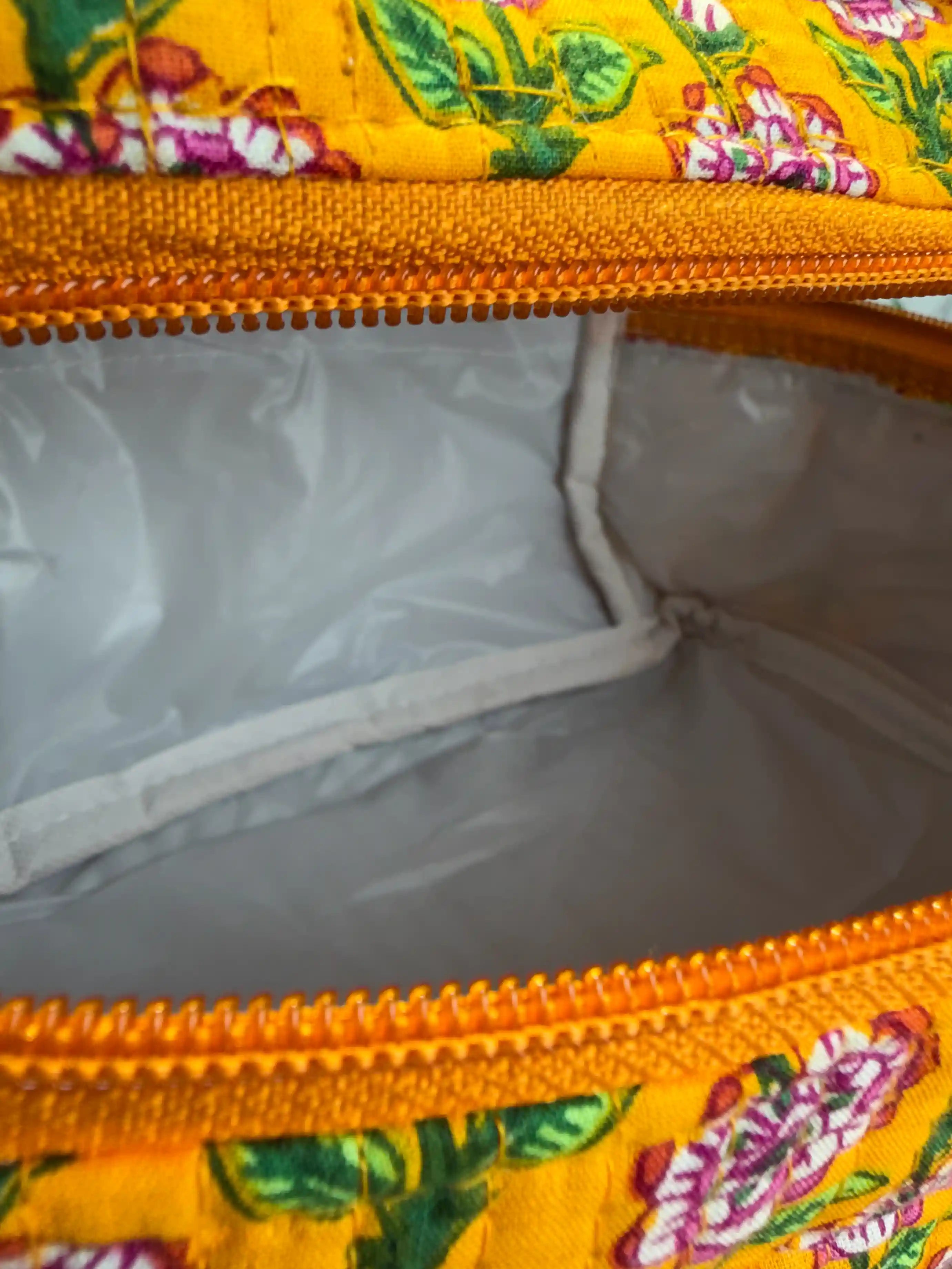 Bright yellow quilted cotton cosmetic vanity bag with purple and green multicolor floral hand block design, cheerful handcrafted makeup organizer for daily use
