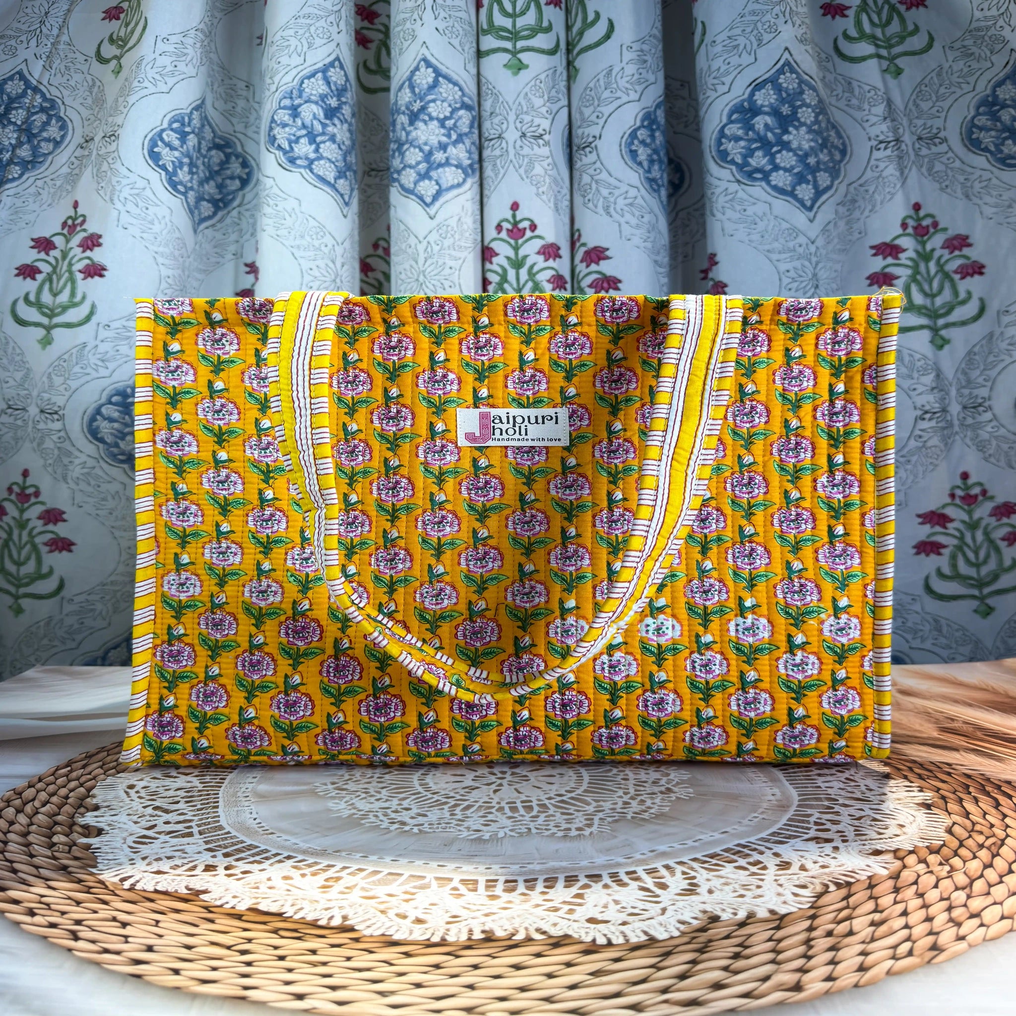 Bright yellow quilted cotton open mini tote with multicolor floral hand block print and striped borders, cheerful handcrafted mini carryall for daily use.