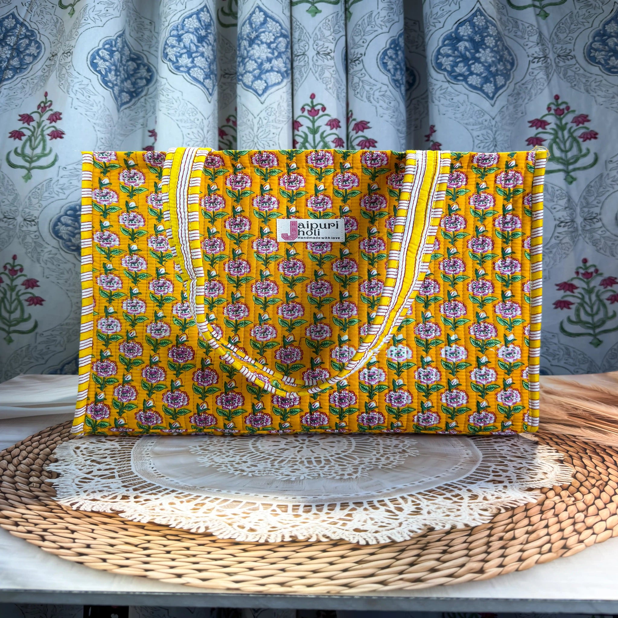 Bright yellow quilted cotton open mini tote with multicolor floral hand block print and striped borders, cheerful handcrafted mini carryall for daily use.