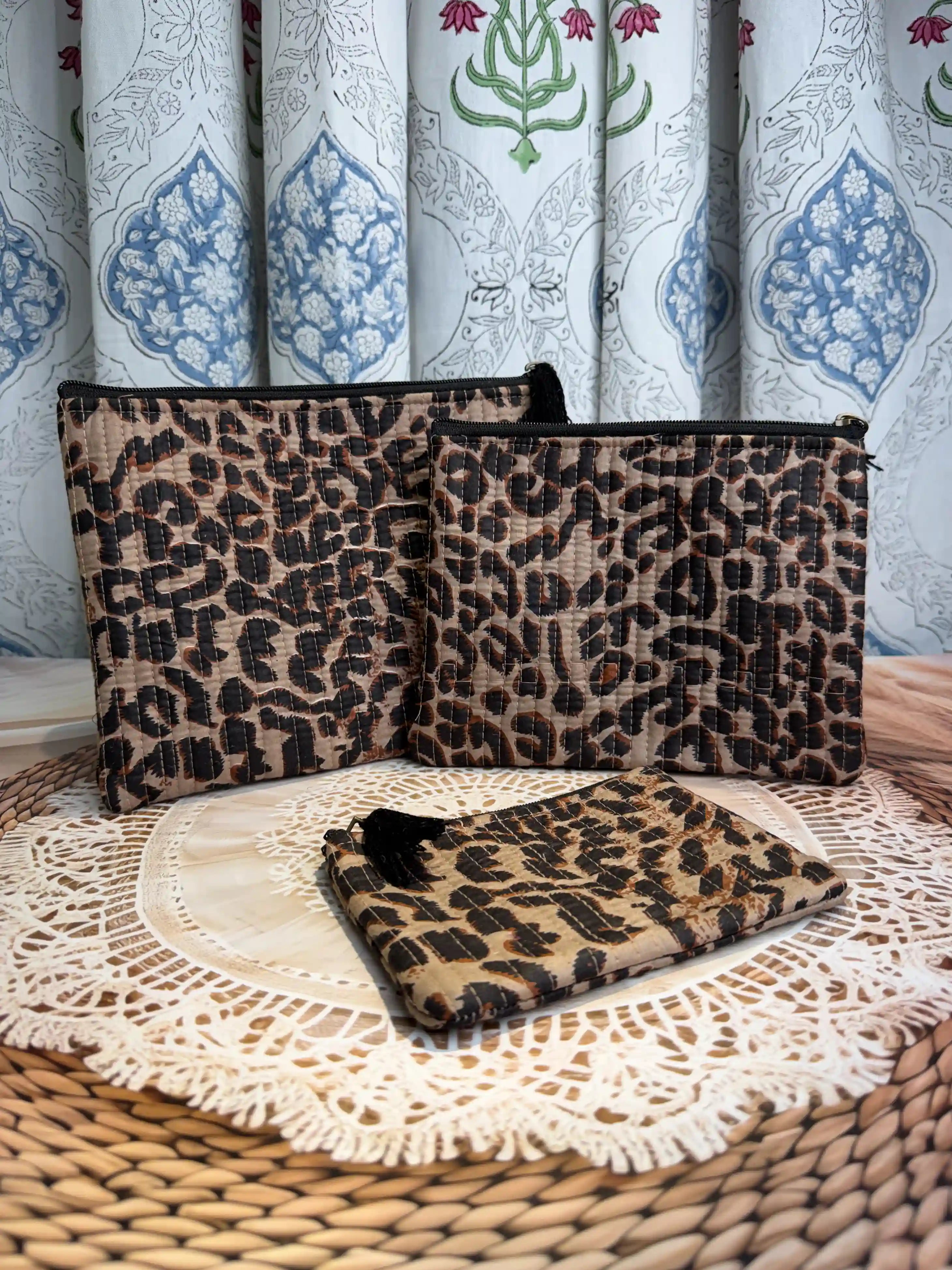 Brown quilted cotton flat pouch set with leopard print hand block pattern, animal print three-piece zipper organizer for makeup and travel storage.
