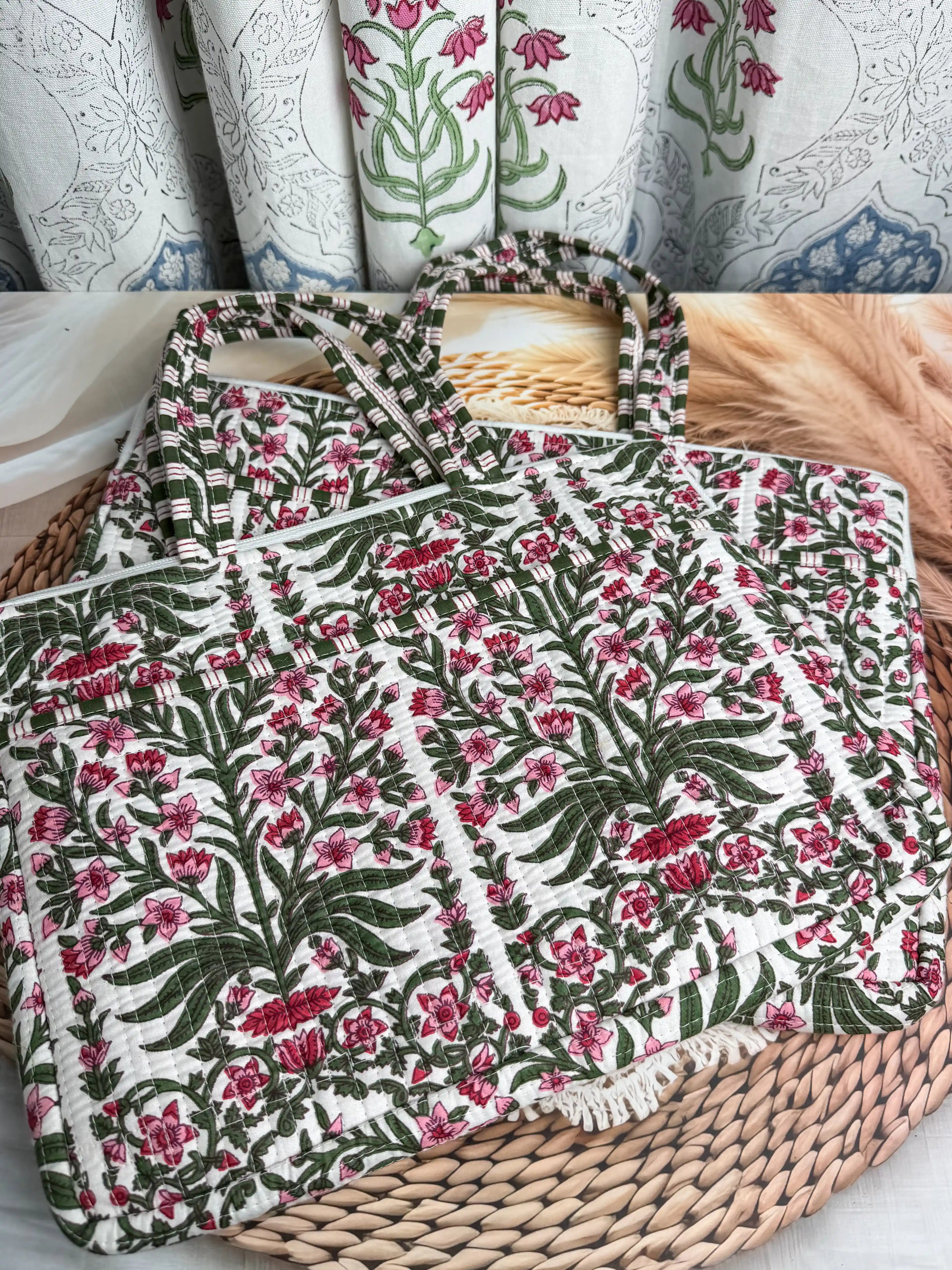 Deep burgundy quilted cotton laptop bag with red and green floral hand block design and cream striped borders, padded handmade laptop sleeve