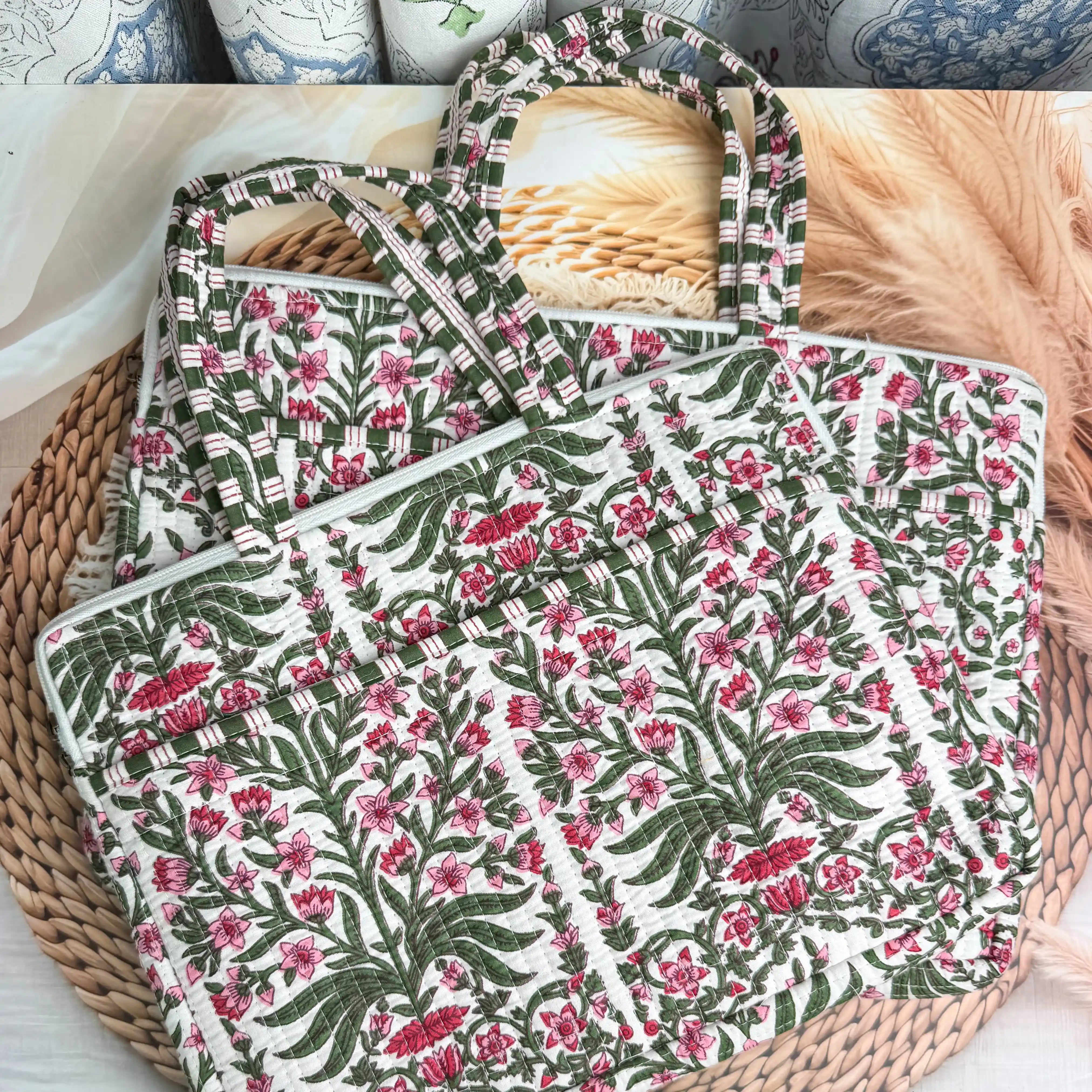 Deep burgundy quilted cotton laptop bag with red and green floral hand block design and cream striped borders, padded handmade laptop sleeve