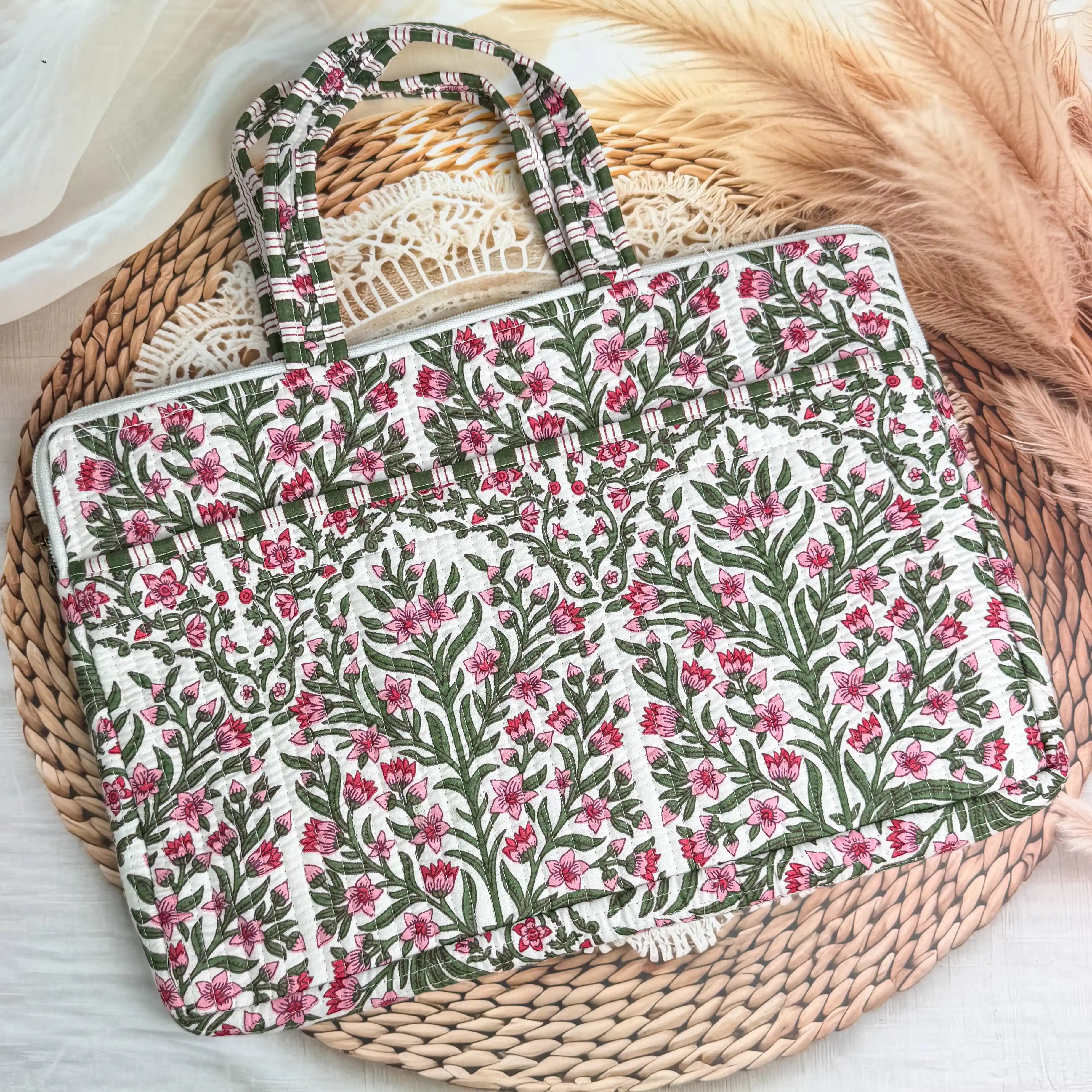 Deep burgundy quilted cotton laptop bag with red and green floral hand block design and cream striped borders, padded handmade laptop sleeve