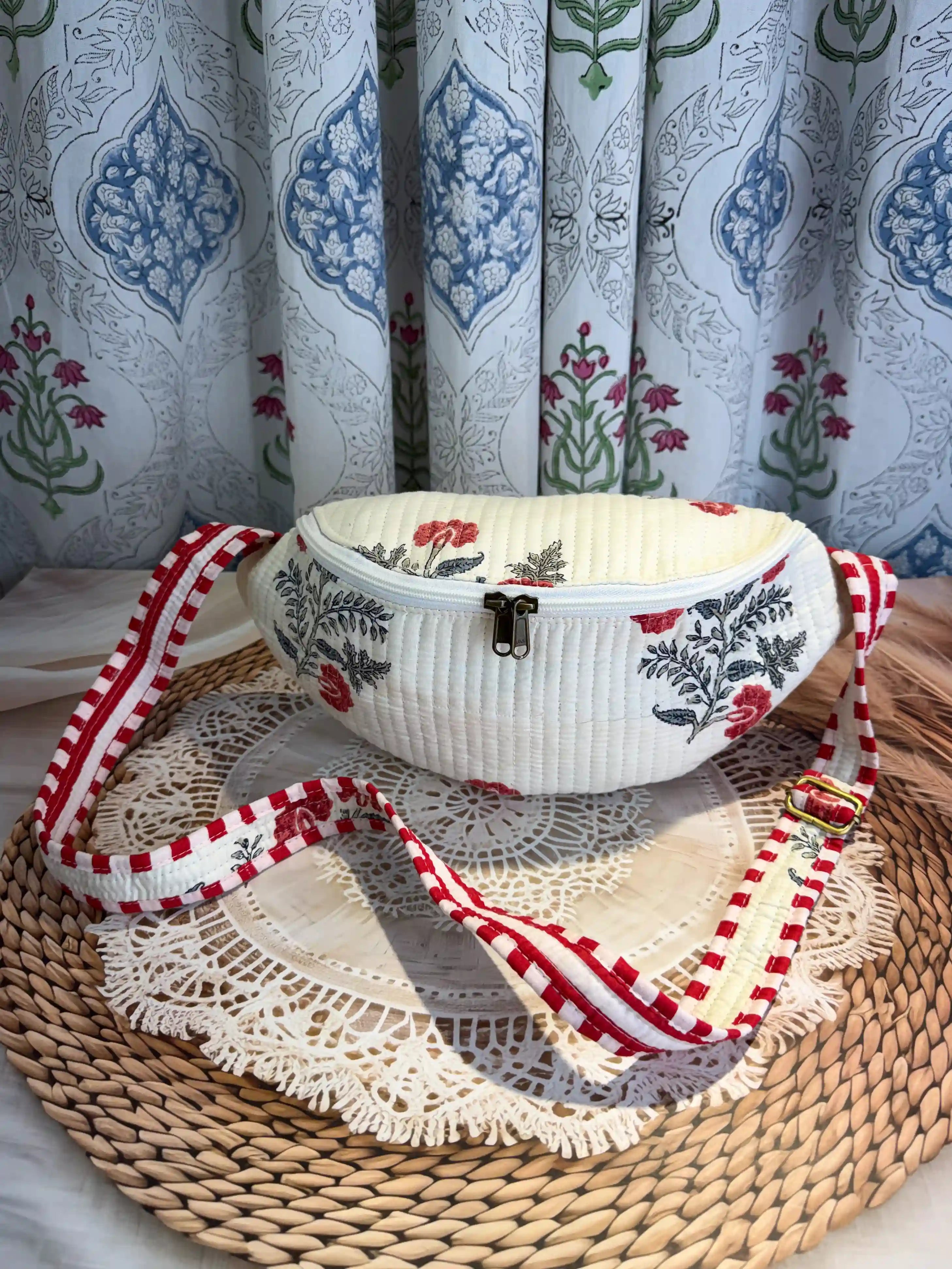 Cream quilted cotton fanny bag with red and green floral botanical hand block design, checkered waist strap for hands-free travel