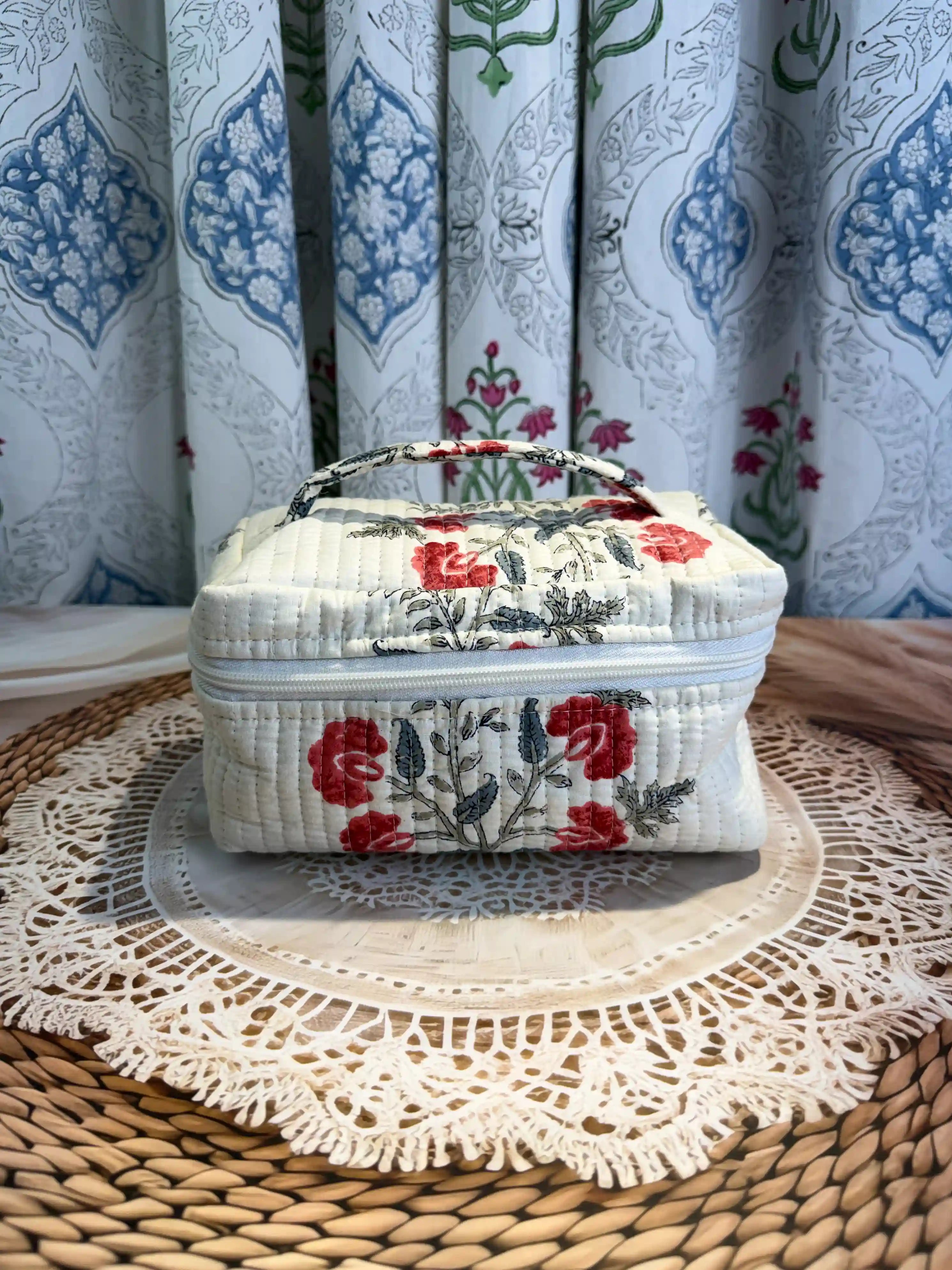 Cream quilted cotton cosmetic vanity bag with red and green floral hand block design, botanical print handmade pouch for daily makeup and toiletry storage