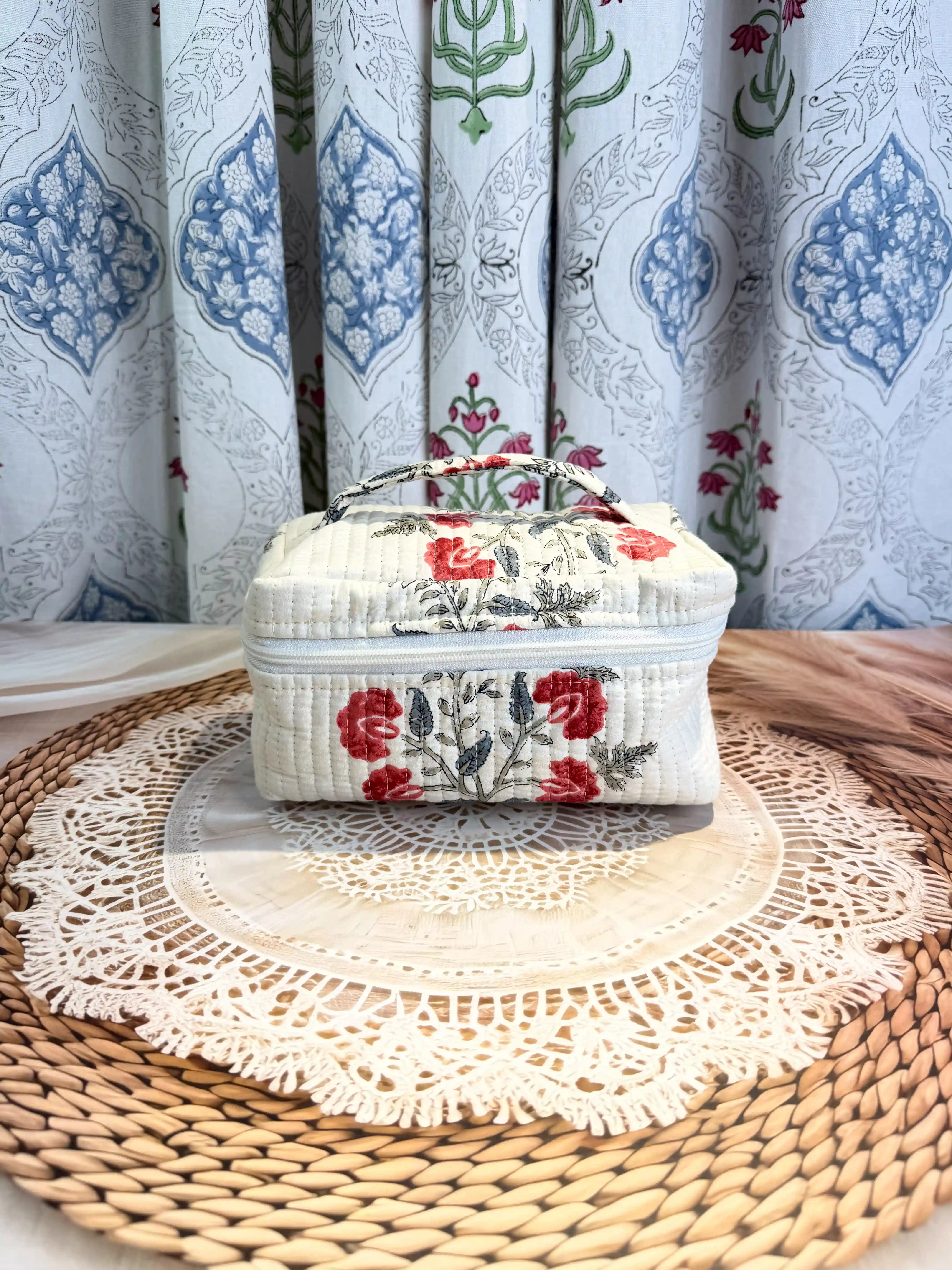 Cream quilted cotton cosmetic vanity bag with red and green floral hand block design, botanical print handmade pouch for daily makeup and toiletry storage
