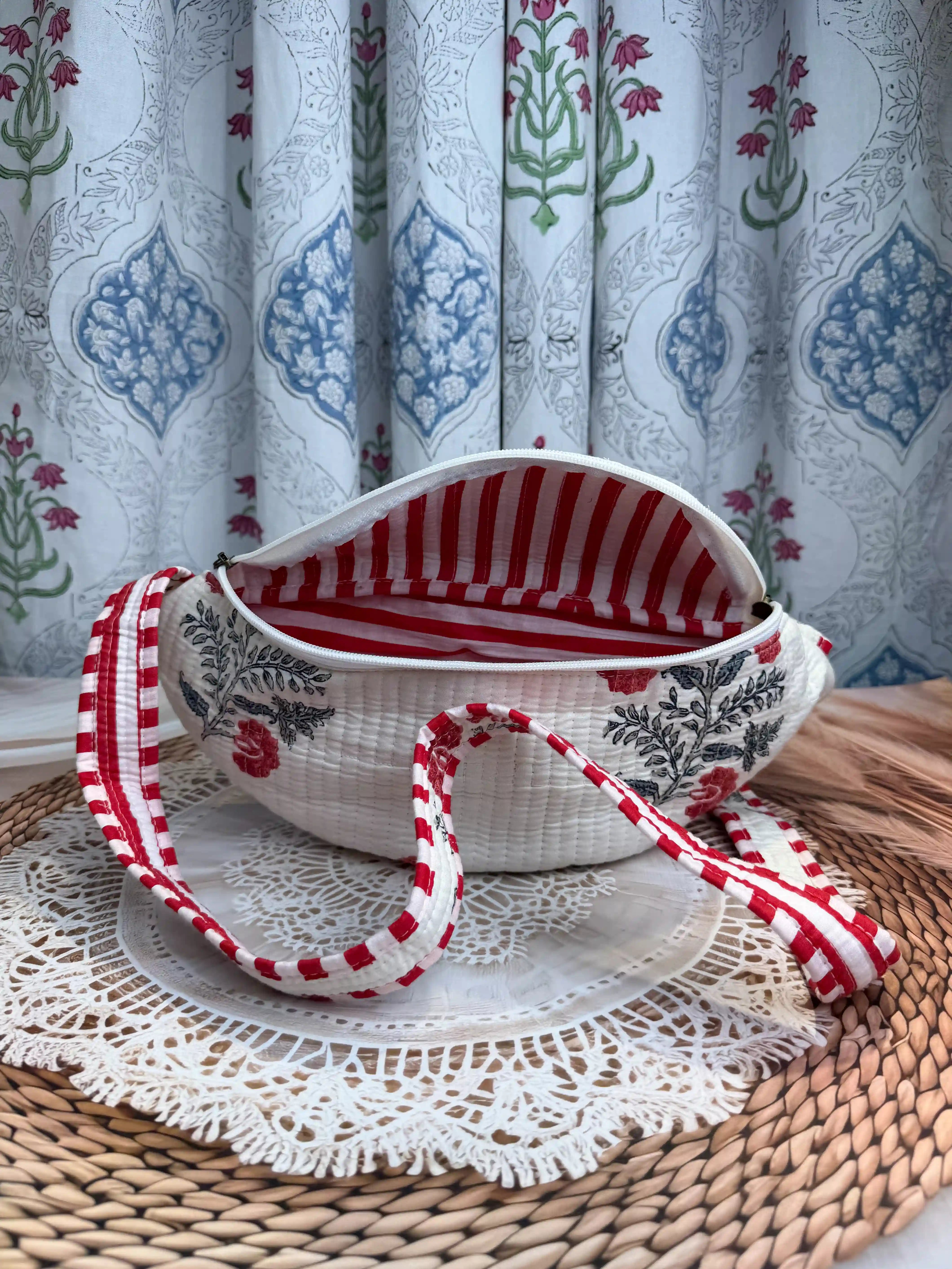 Cream quilted cotton fanny bag with red and green floral botanical hand block design, checkered waist strap for hands-free travel