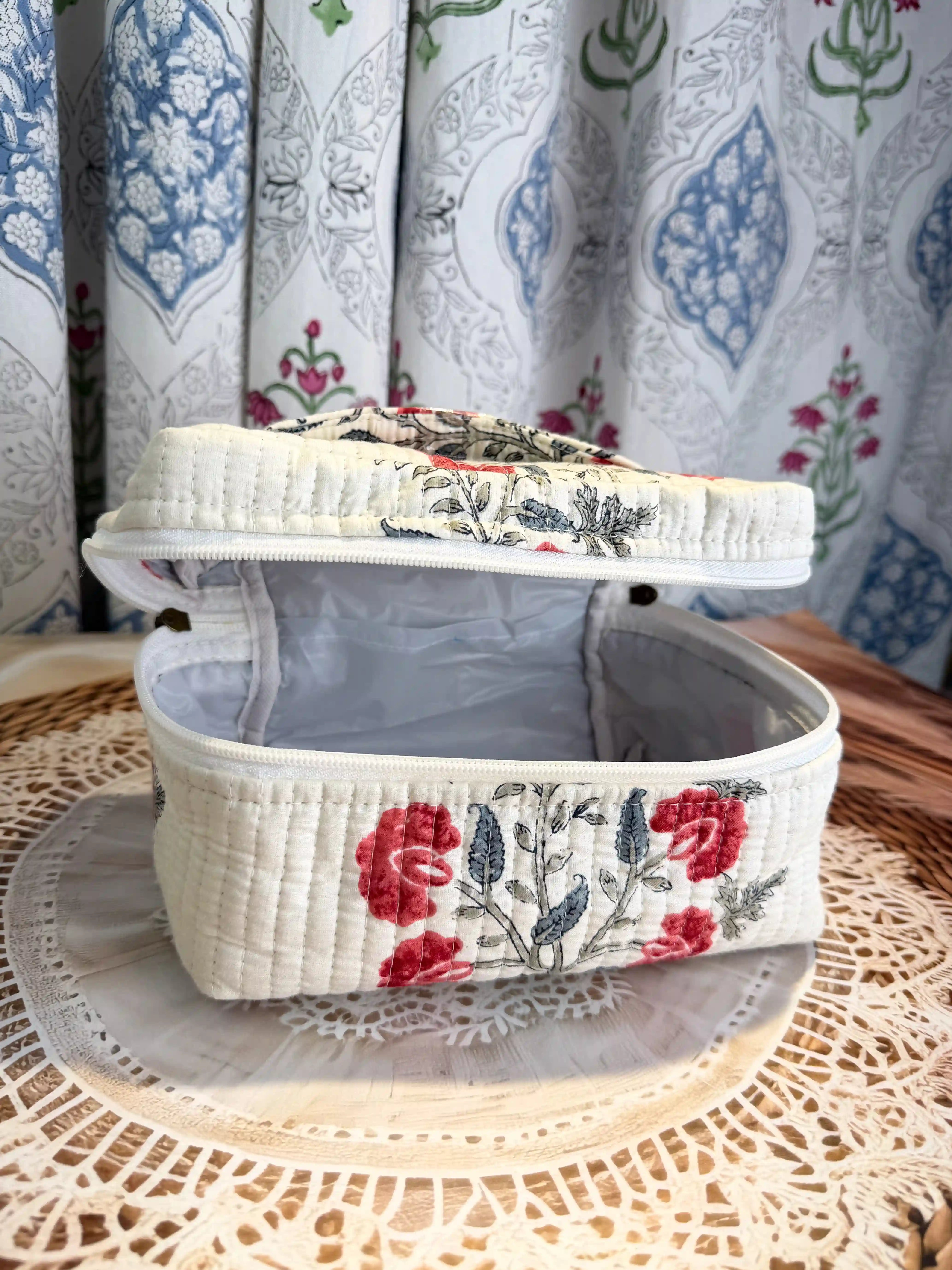 Cream quilted cotton cosmetic vanity bag with red and green floral hand block design, botanical print handmade pouch for daily makeup and toiletry storage