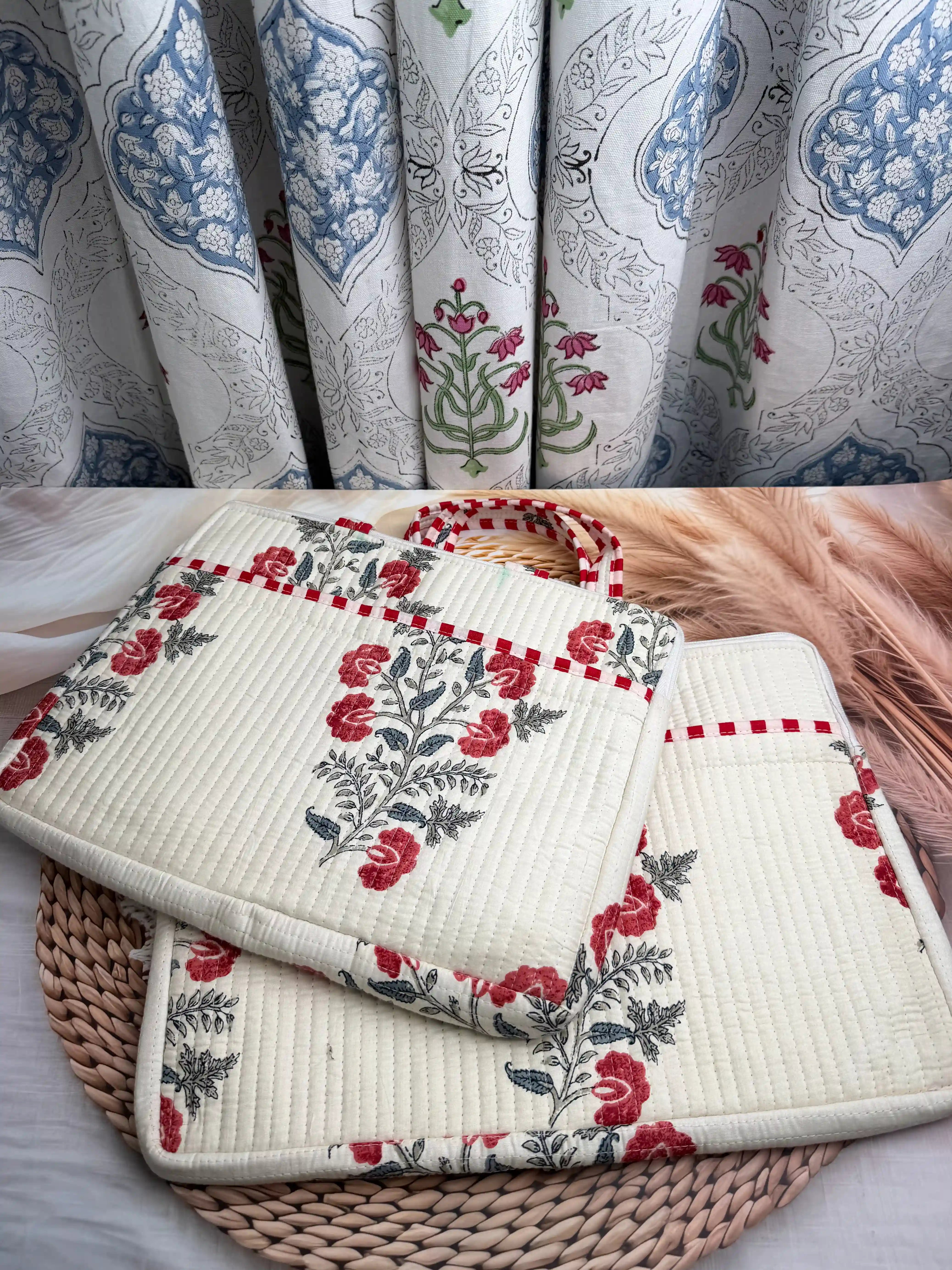 Cream quilted cotton laptop bag with red and green floral hand block design and dotted red borders, padded laptop cover for daily commute
