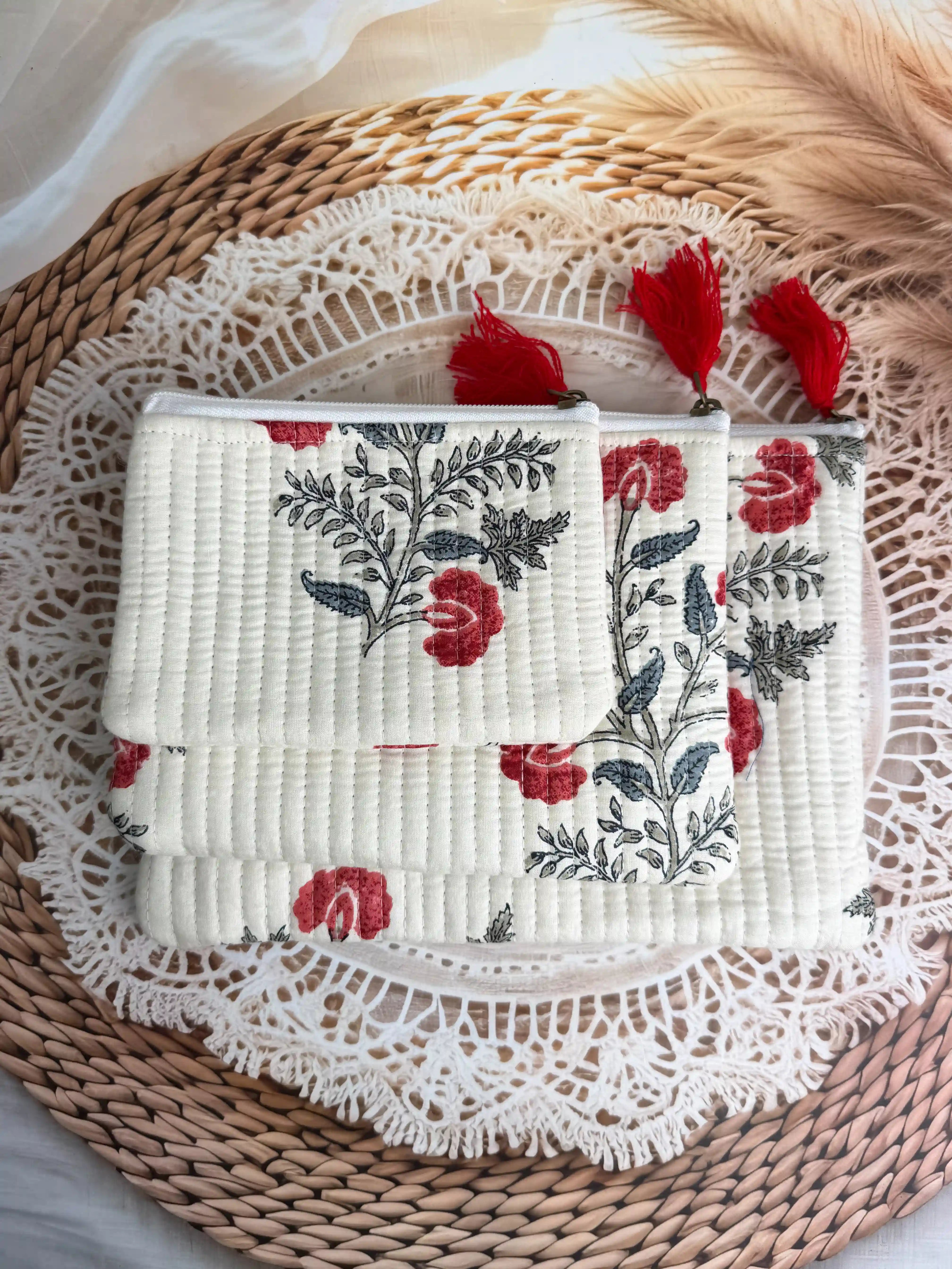 Cream quilted cotton flat pouch set with red botanical floral hand block design, three-piece handmade zipper organizer for daily grooming essentials.