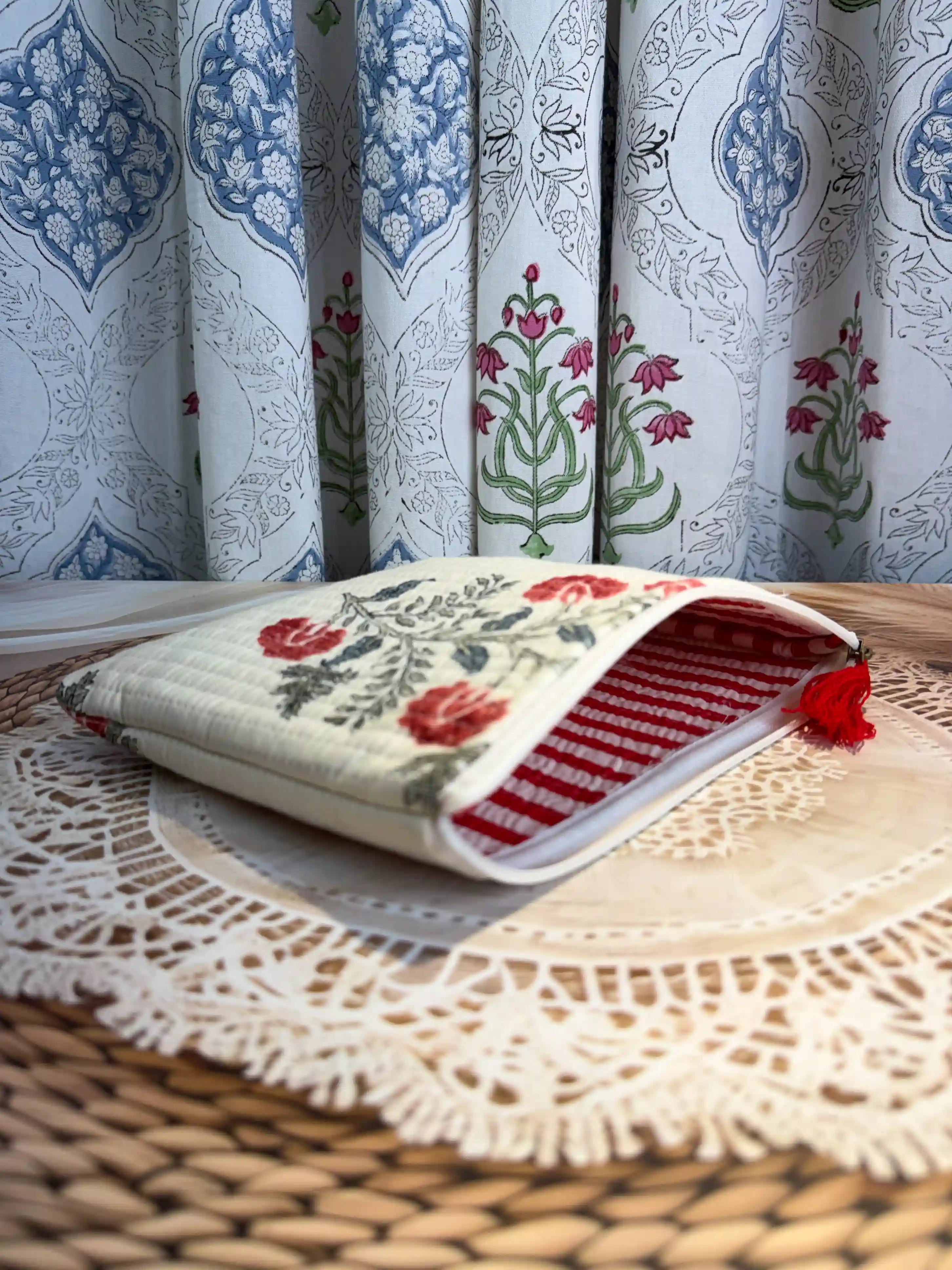 Cream quilted cotton flat pouch set with red botanical floral hand block design, three-piece handmade zipper organizer for daily grooming essentials.