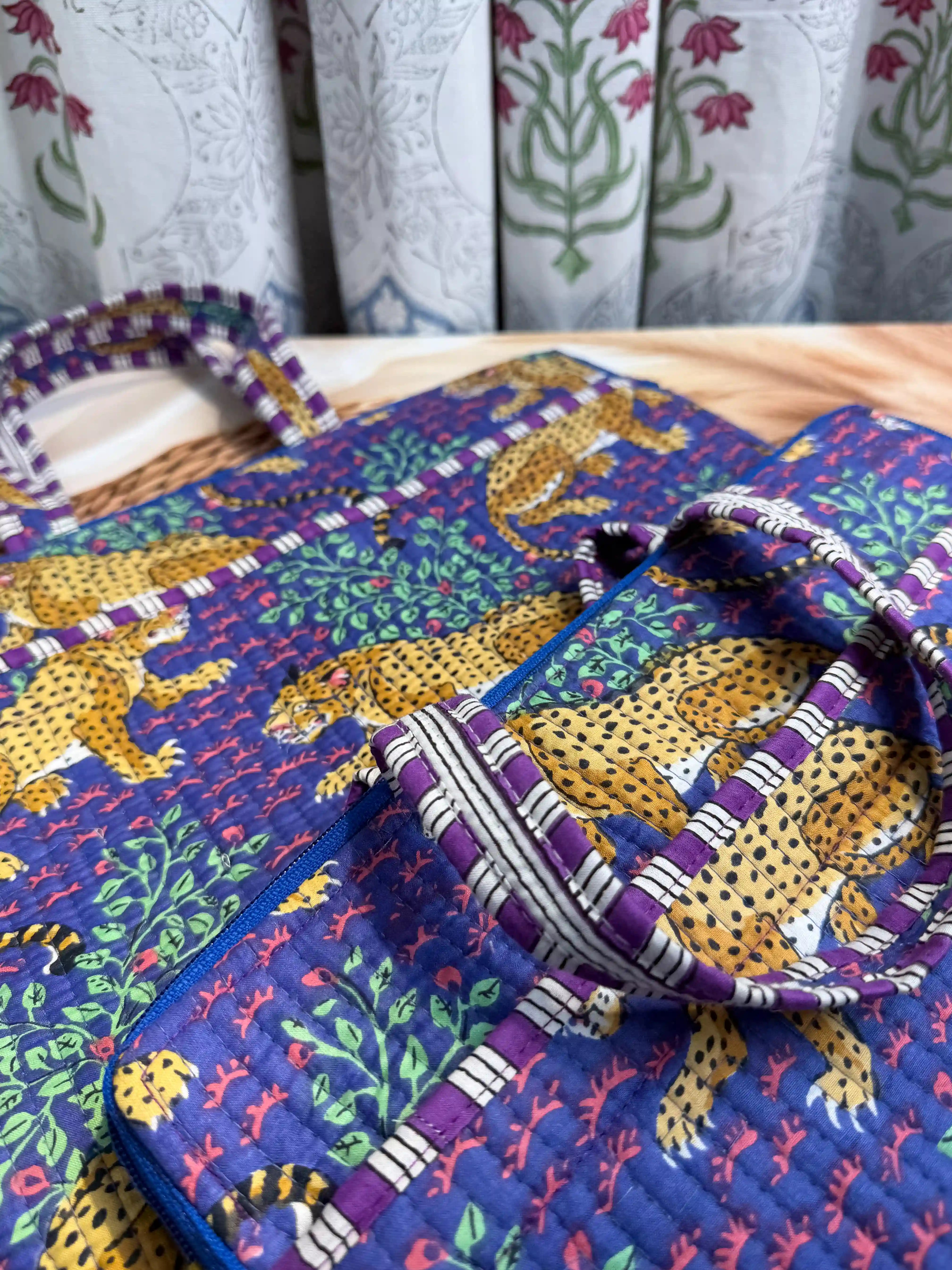 Deep navy quilted cotton laptop bag with yellow elephant print hand block design and purple striped borders, animal print padded laptop sleeve