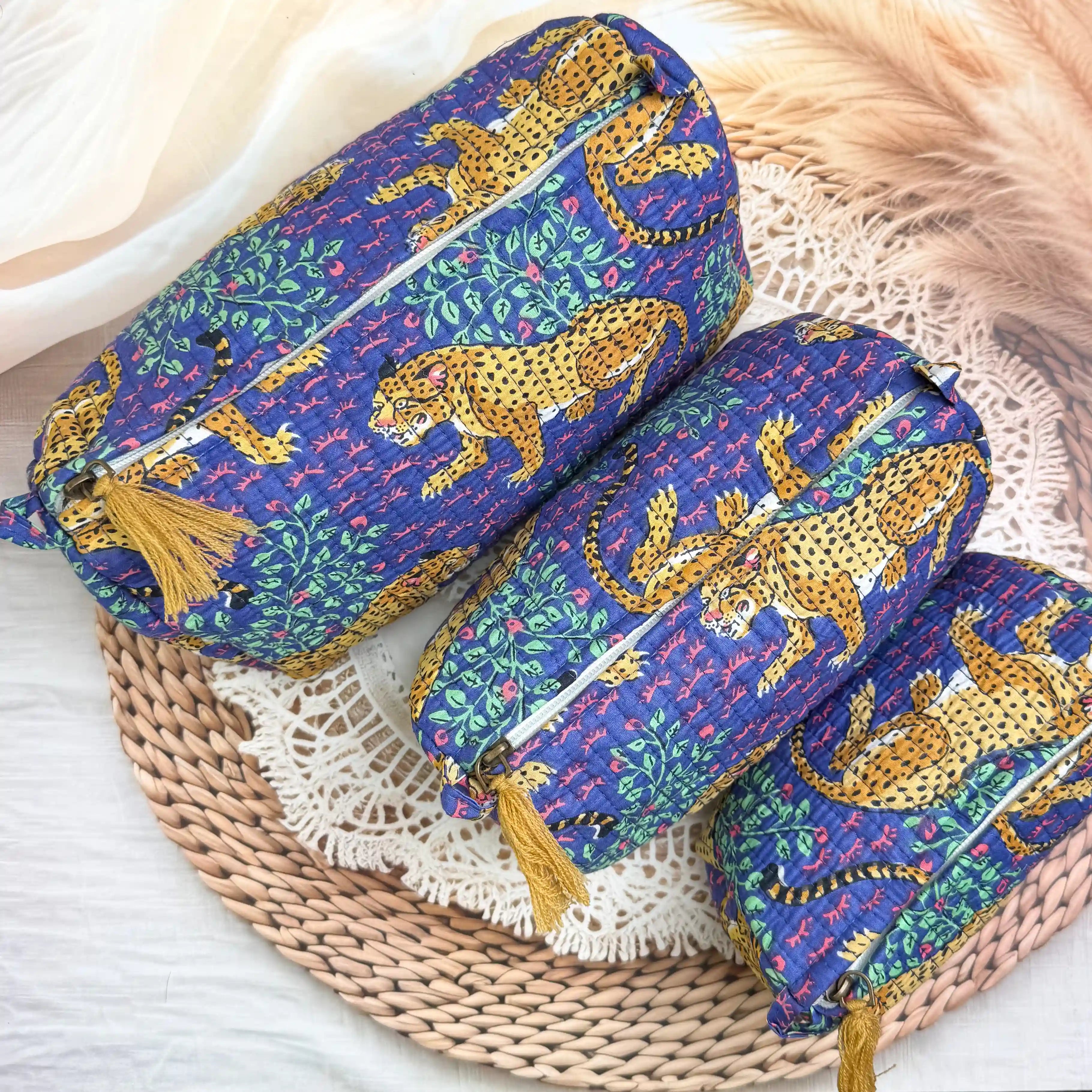 Deep blue quilted cotton toiletry pouch set with yellow leopard print hand block design, animal print three-piece organizer for bathroom essentials.
