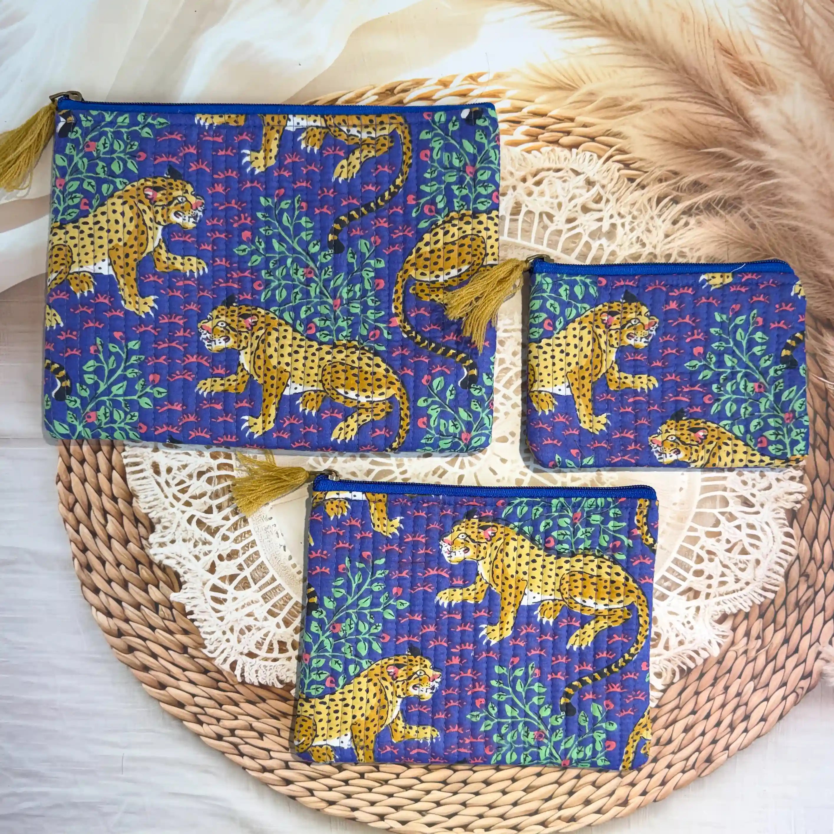 Deep blue quilted cotton flat pouch set with yellow leopard print hand block design, animal print three-piece zipper organizer for travel essentials.