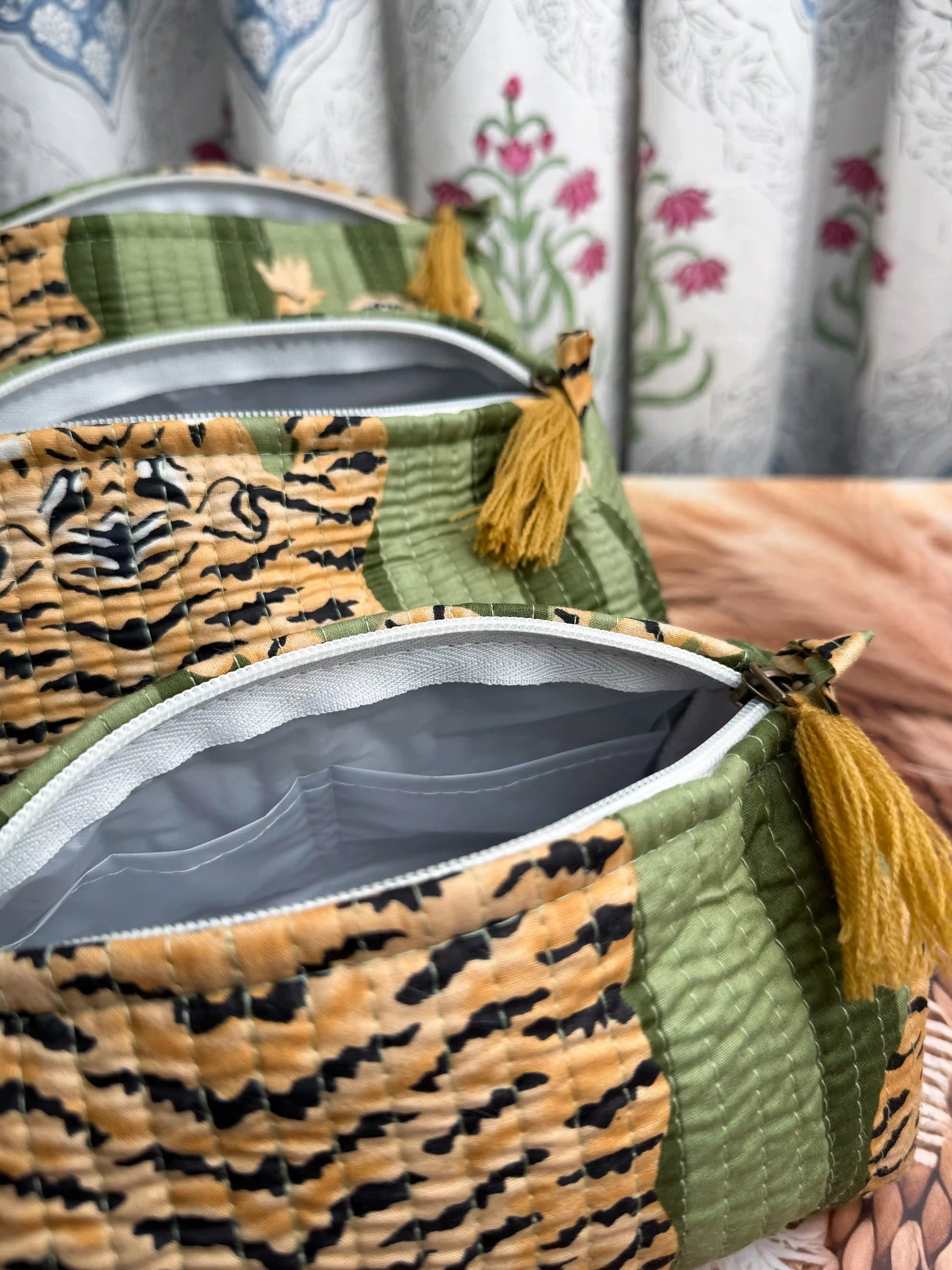 Green quilted cotton toiletry pouch set with yellow tiger print hand block pattern, animal print three-piece handmade travel organizer for toiletries.