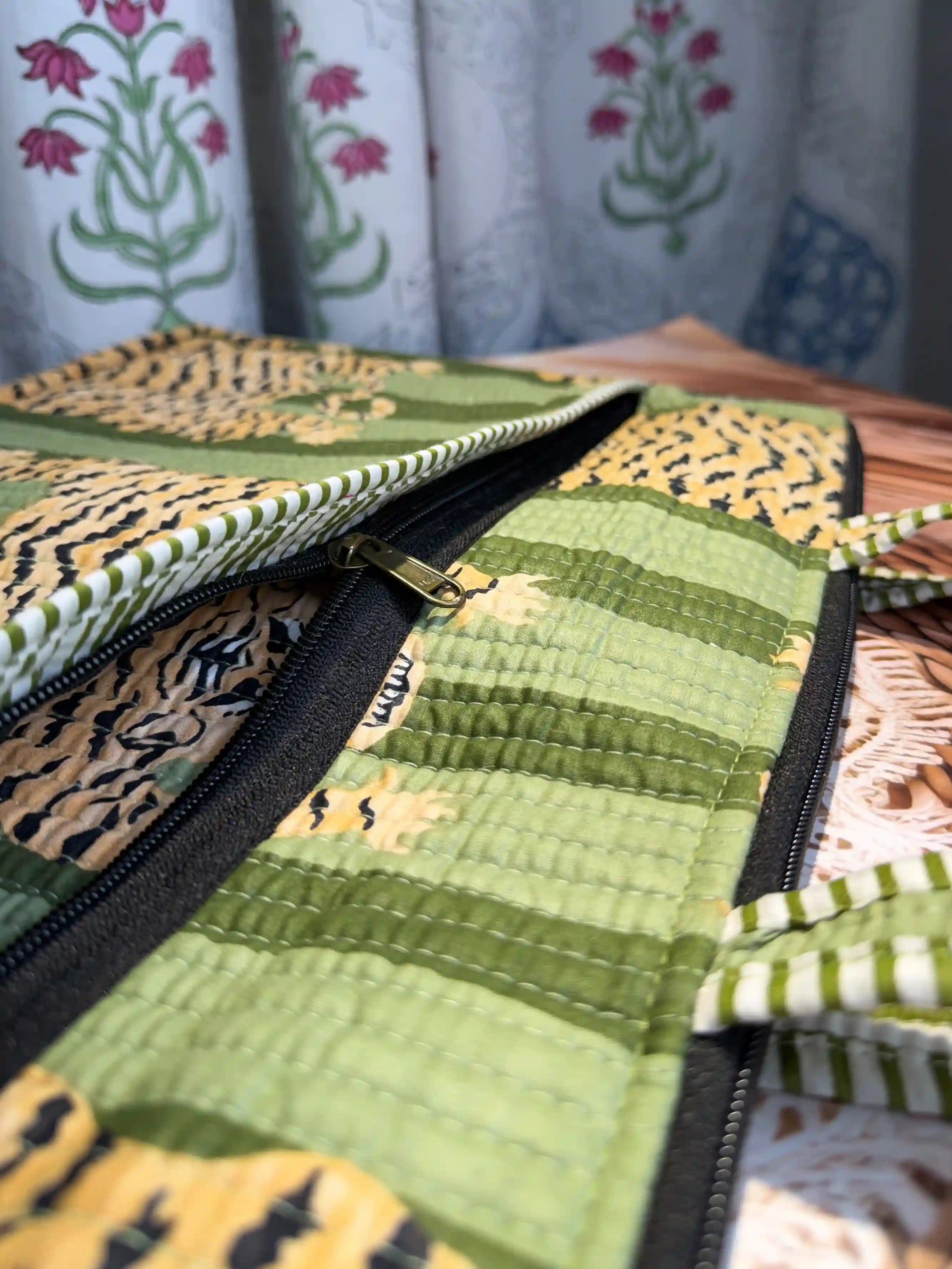 Green quilted cotton laptop bag with tiger print hand block pattern and white striped borders, padded handmade sleeve for office and travel
