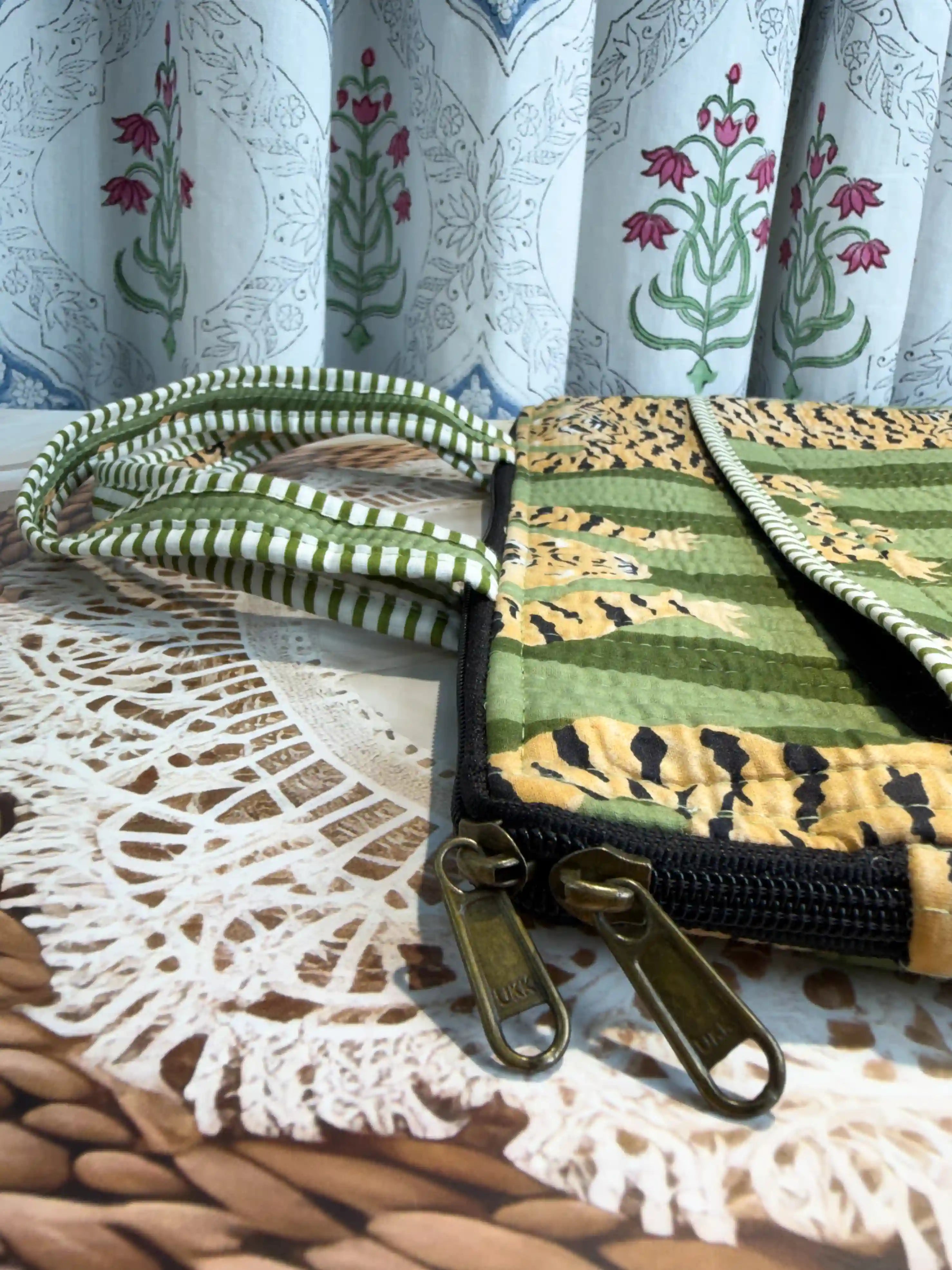 Green quilted cotton laptop bag with tiger print hand block pattern and white striped borders, padded handmade sleeve for office and travel