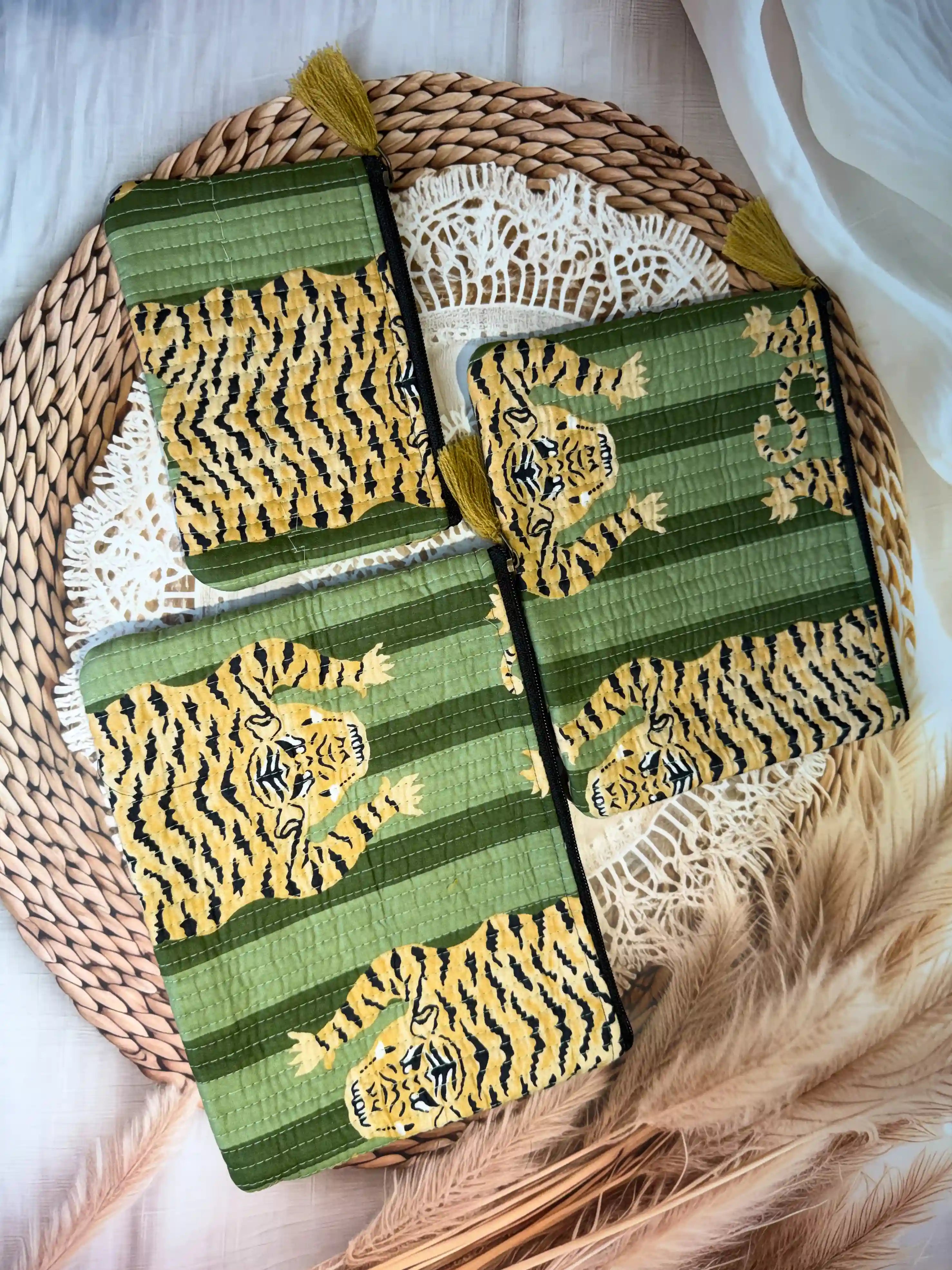 Green quilted cotton flat pouch set with yellow animal print hand block pattern, three-piece lightweight handcrafted zipper pouches for organization.