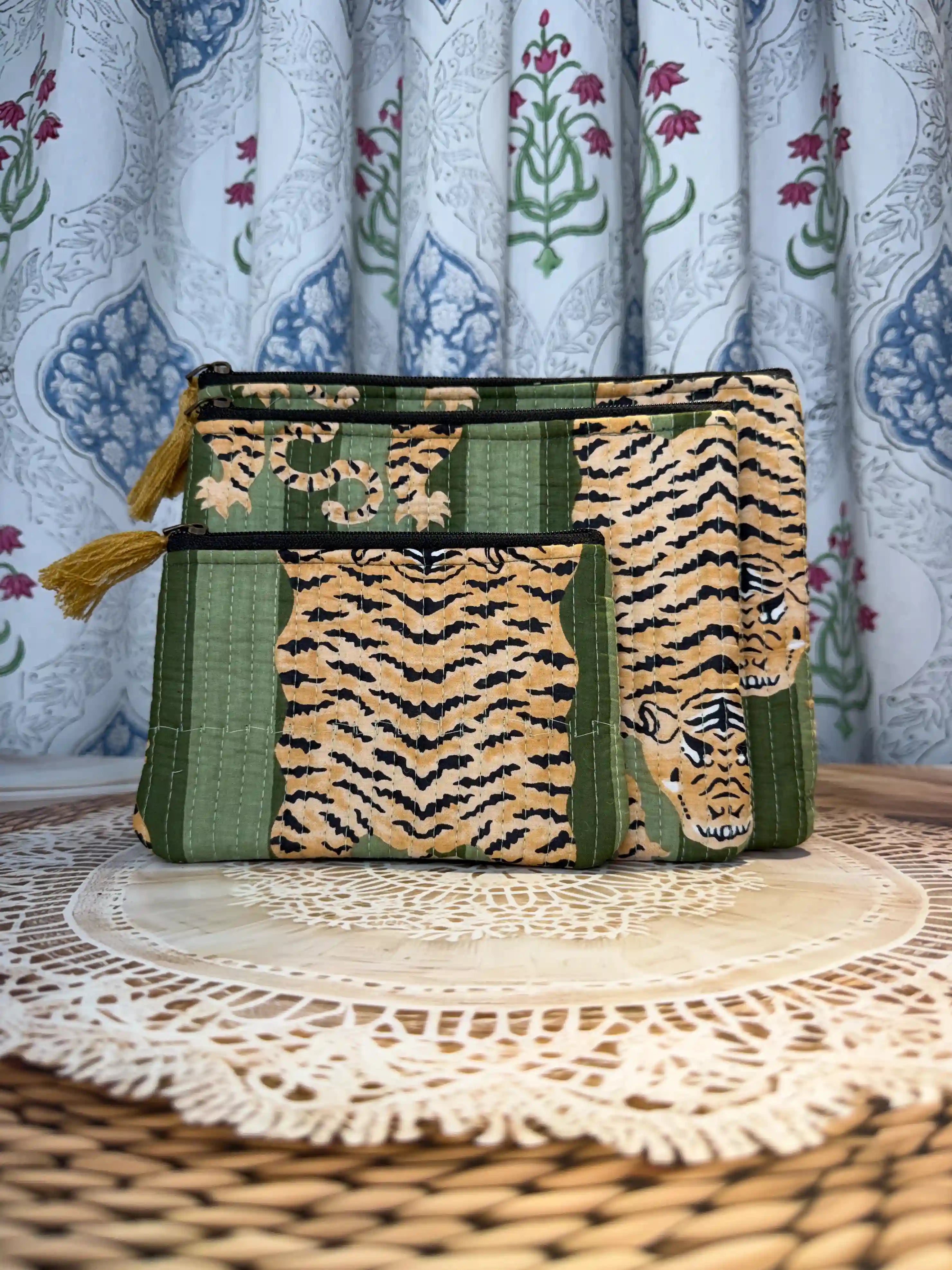 Green quilted cotton flat pouch set with yellow animal print hand block pattern, three-piece lightweight handcrafted zipper pouches for organization.