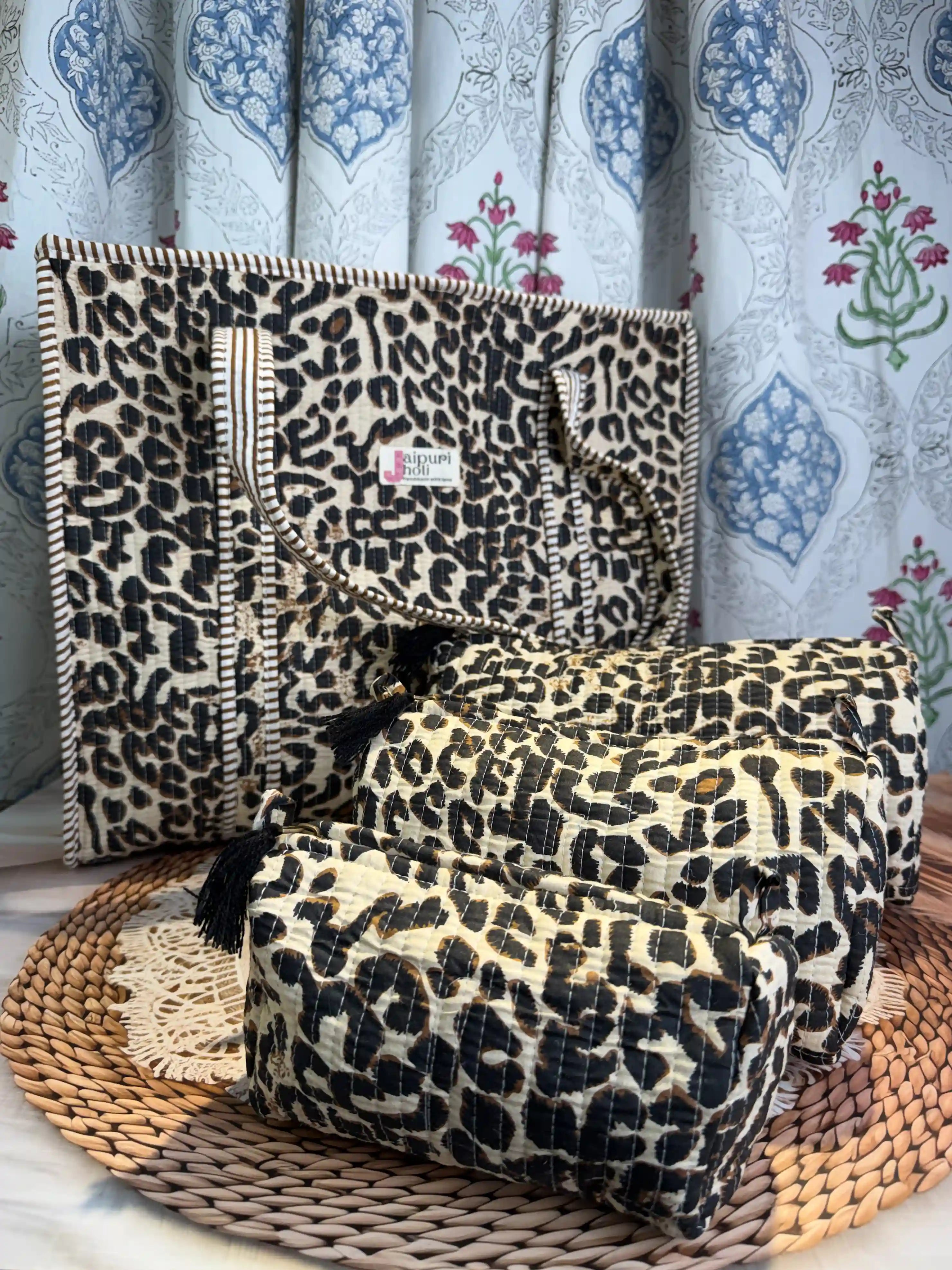 Handcrafted leopard print cotton quilted tote bag with sturdy handles and matching 3-piece toiletry pouch set, featuring zip closure and spacious single compartments, ethically made in Jaipur, India, ideal for everyday use, travel, skincare, cosmetics, and innerwear storage.