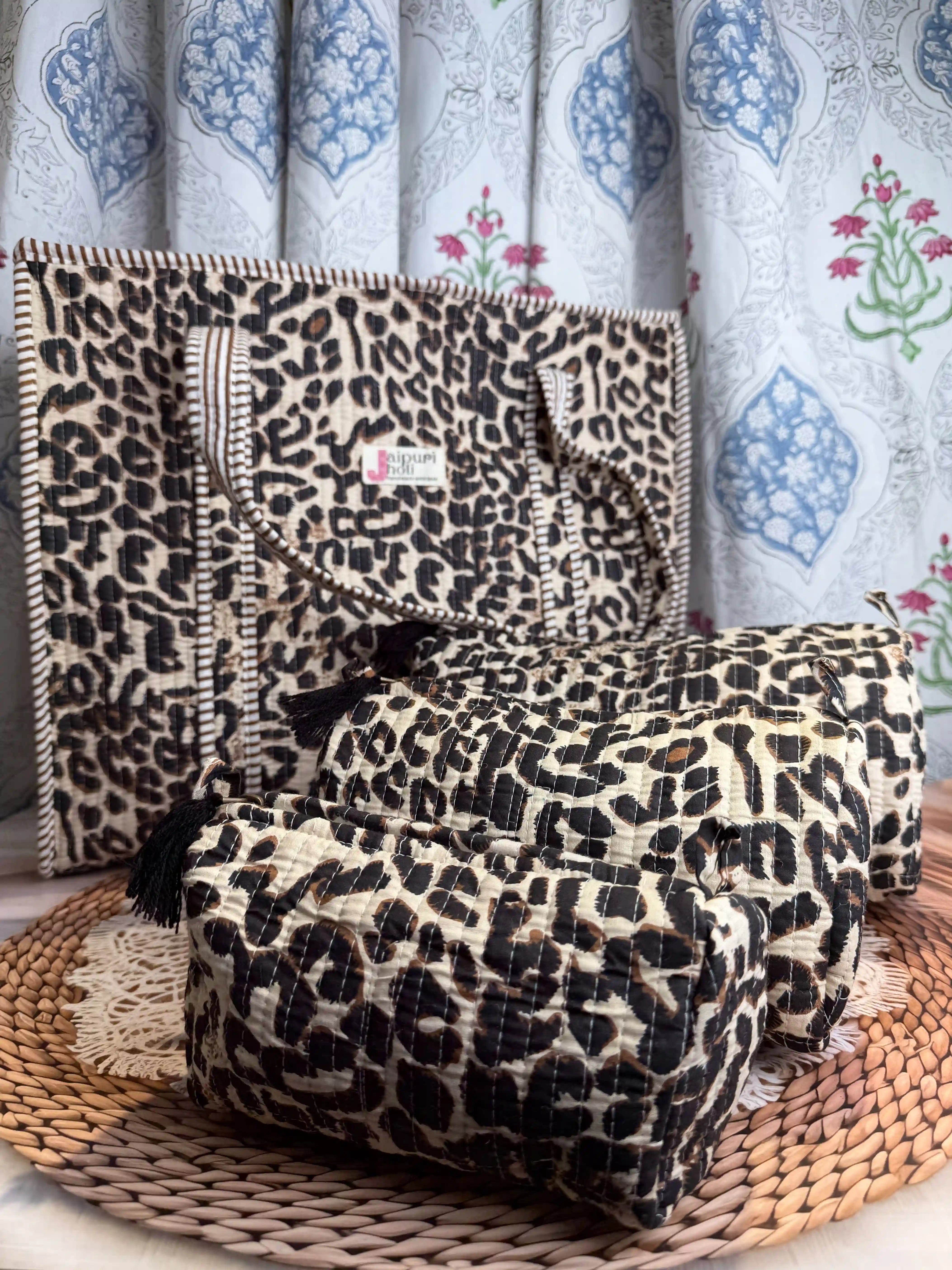 Handcrafted leopard print cotton quilted tote bag with sturdy handles and matching 3-piece toiletry pouch set, featuring zip closure and spacious single compartments, ethically made in Jaipur, India, ideal for everyday use, travel, skincare, cosmetics, and innerwear storage.