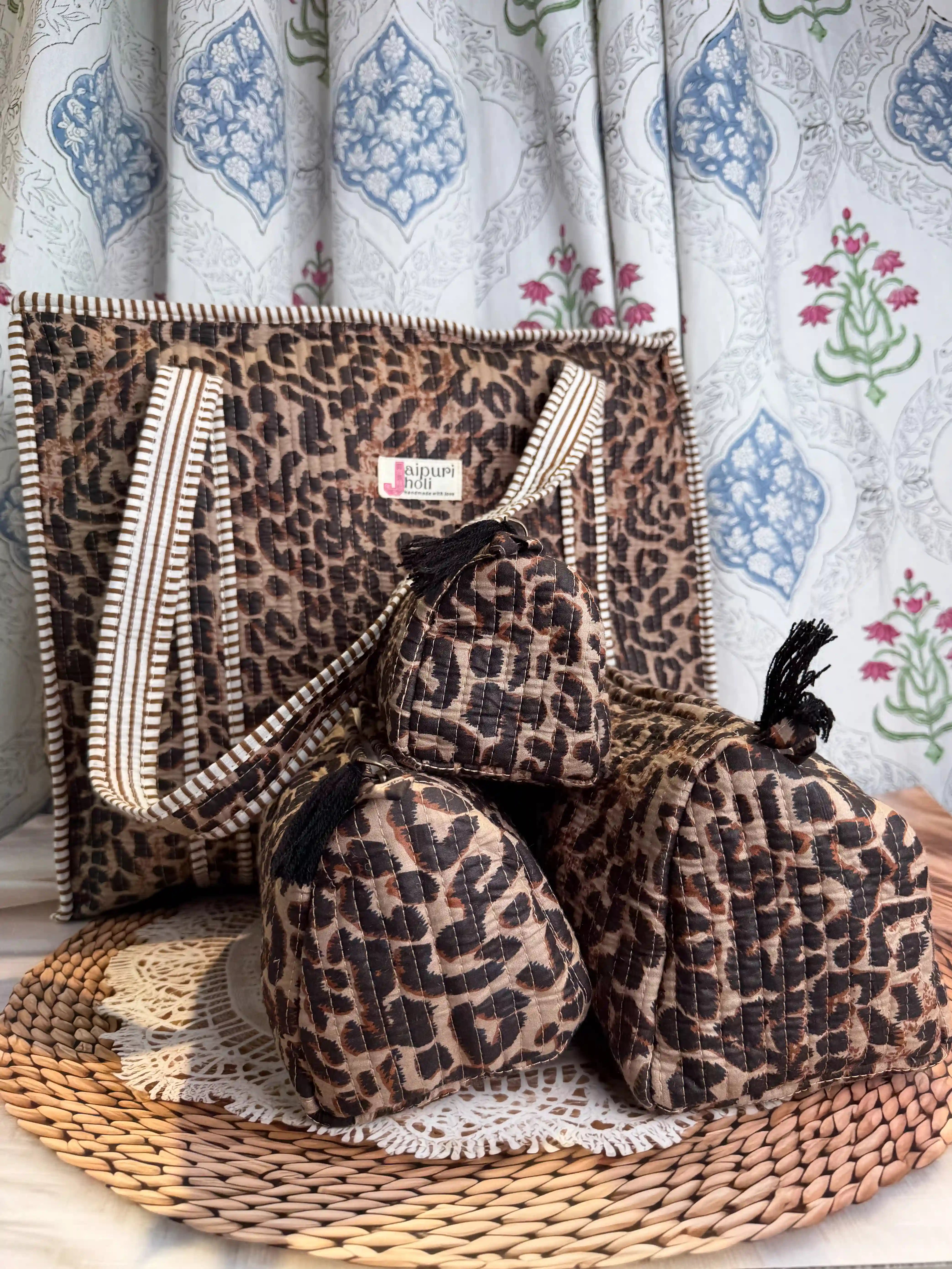 Handcrafted leopard print cotton quilted tote bag with sturdy striped handles and matching 3-piece zippered toiletry pouch set, featuring soft quilted texture and single compartments, ethically made in Jaipur, India, ideal for everyday use, travel, cosmetics, skincare, and innerwear storage.
