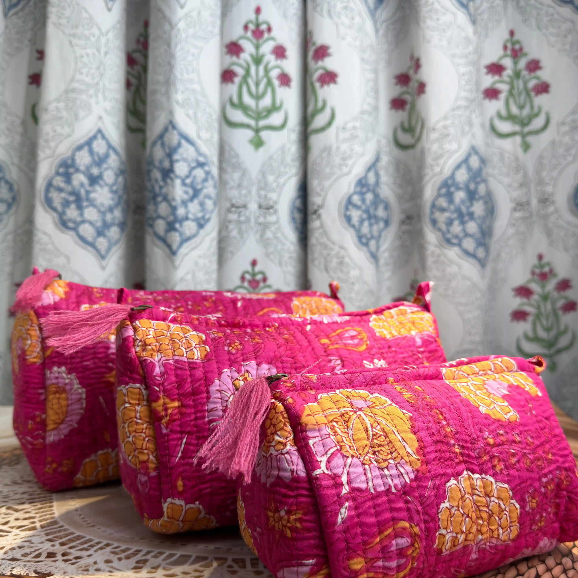 Pink quilted cotton toiletry pouch set with multicolor hand block print, lightweight three-piece handcrafted travel organizer.