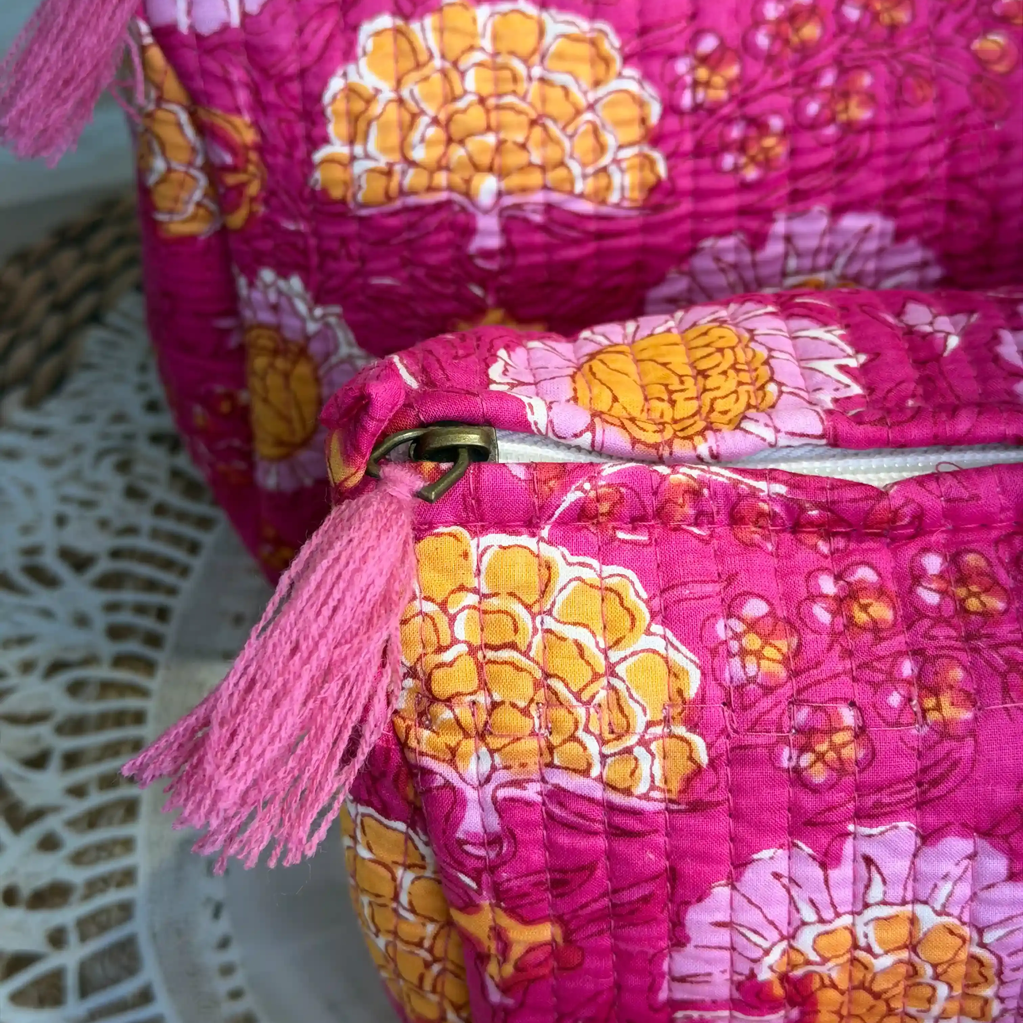 Pink quilted cotton toiletry pouch set with multicolor hand block print, lightweight three-piece handcrafted travel organizer.