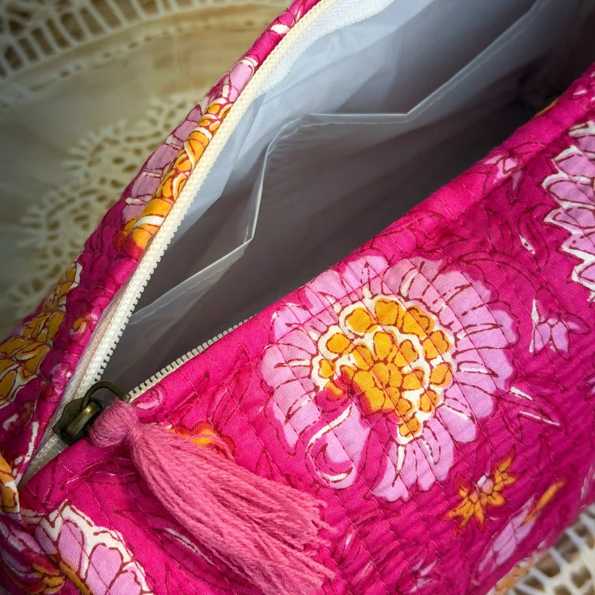 Pink quilted cotton toiletry pouch set with multicolor hand block print, lightweight three-piece handcrafted travel organizer.
