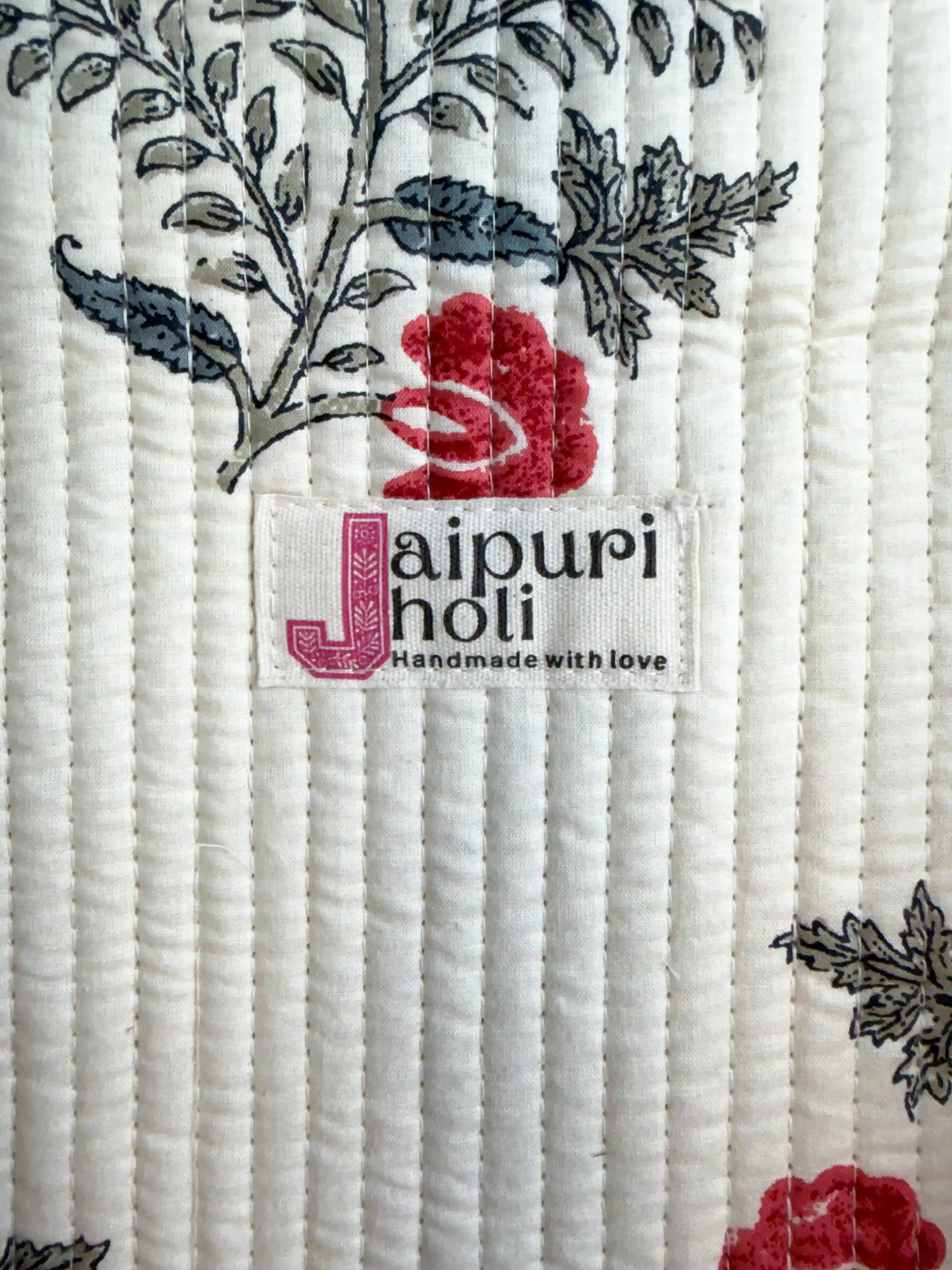 White quilted cotton tote bag with red floral hand block design, red and white striped borders, and zip, premium shoulder tote for daily use.