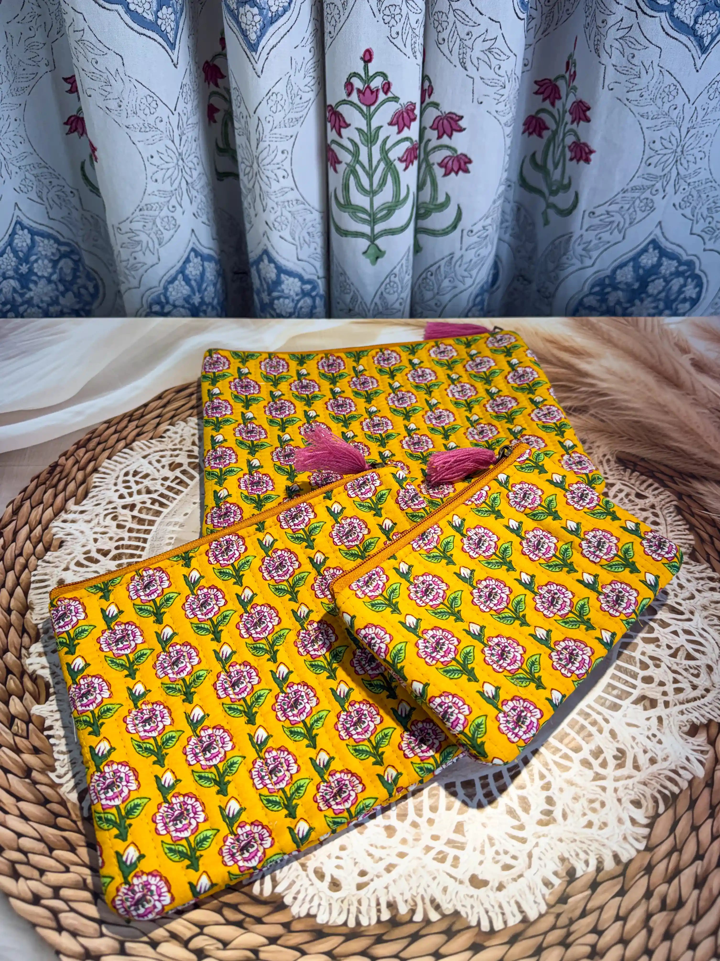 Bright yellow quilted cotton flat pouch set with multicolor floral hand block design, three-piece lightweight handcrafted zipper organizer for daily essentials.