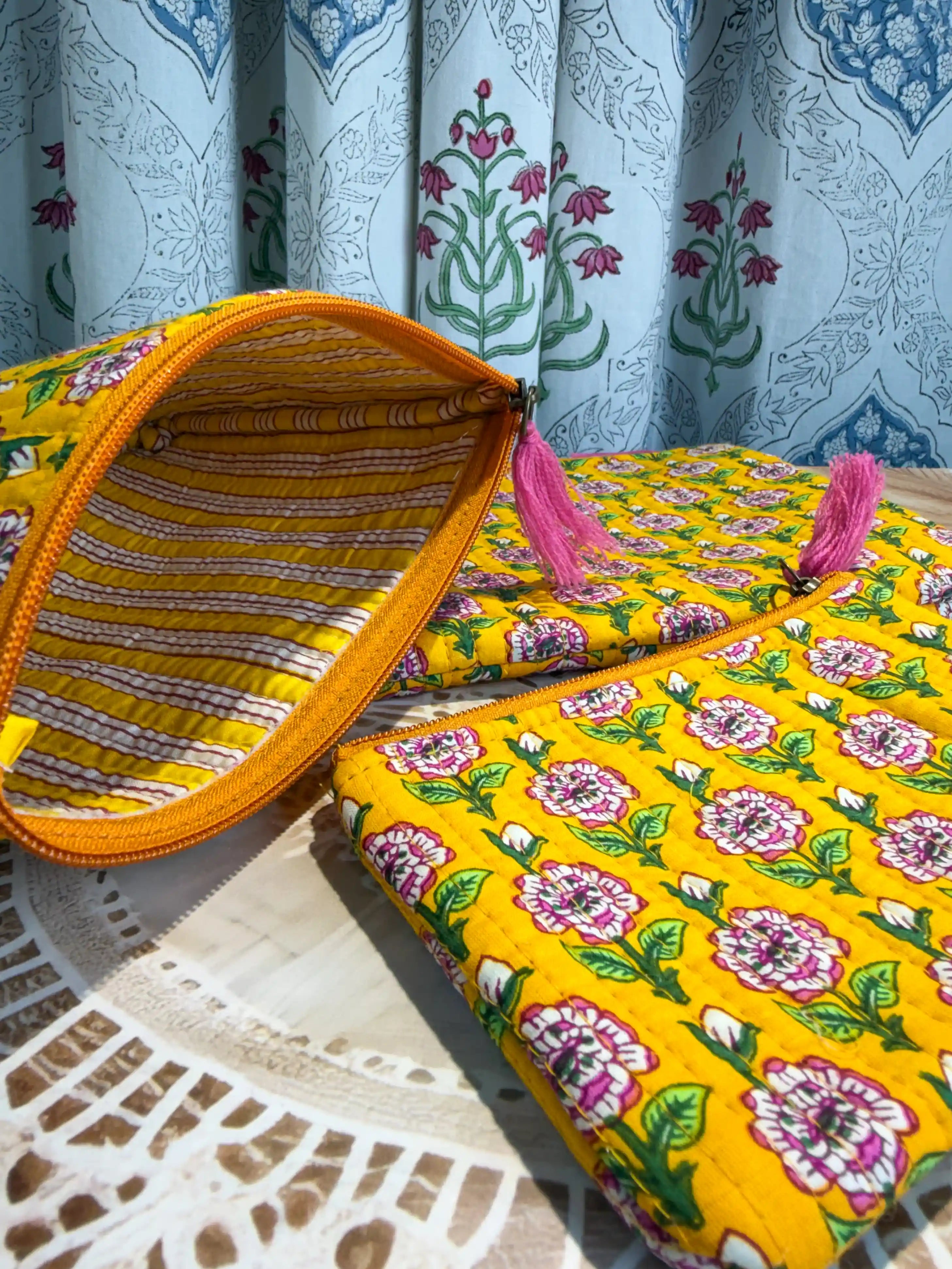 Bright yellow quilted cotton flat pouch set with multicolor floral hand block design, three-piece lightweight handcrafted zipper organizer for daily essentials.