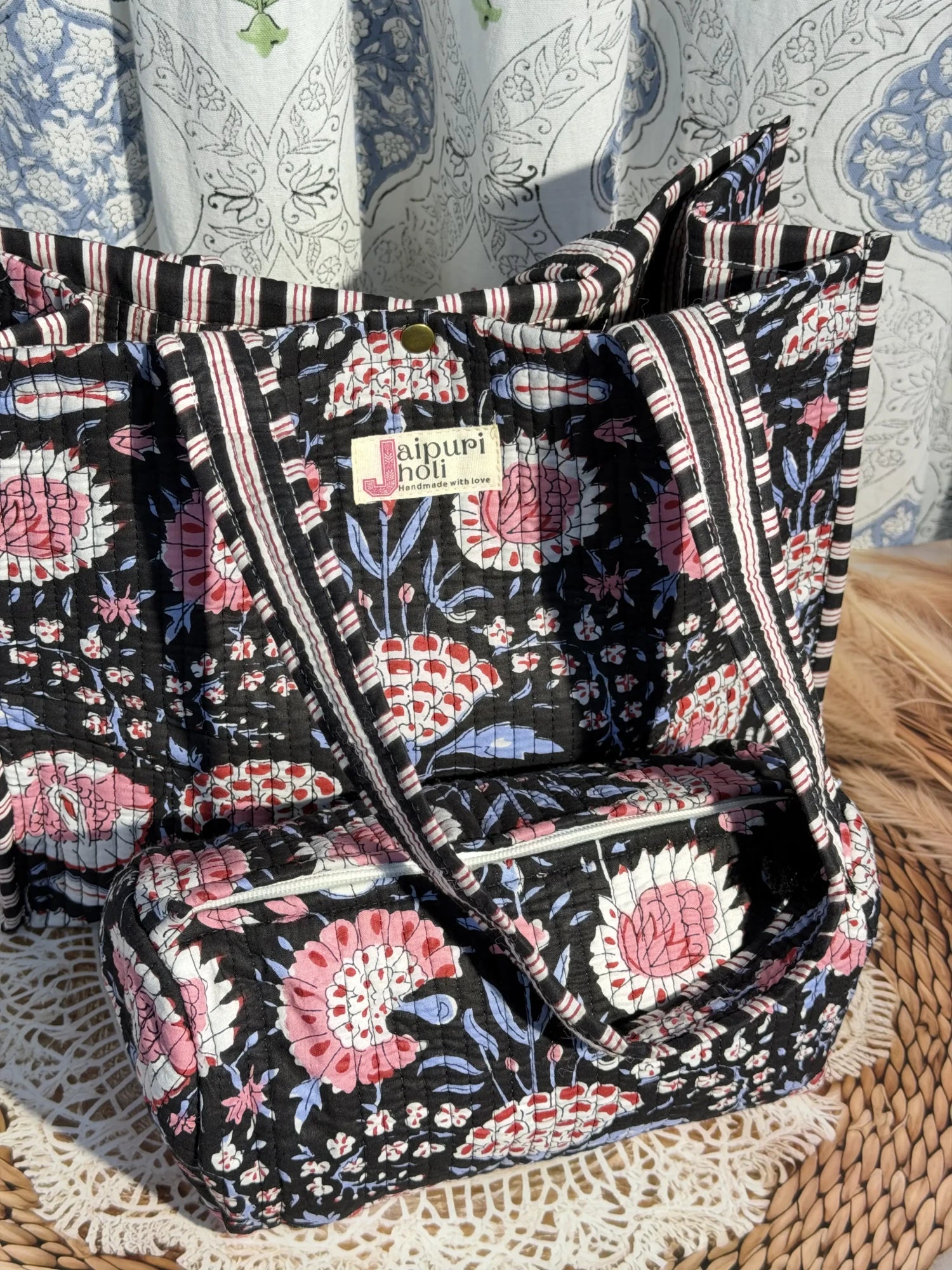 Jaipur block print cotton quilted button tote bag with matching pouch, black and pink floral print, 15×12×6 inch tote with 10×6 inch pouch for storing toiletries, cosmetics and daily essentials front view