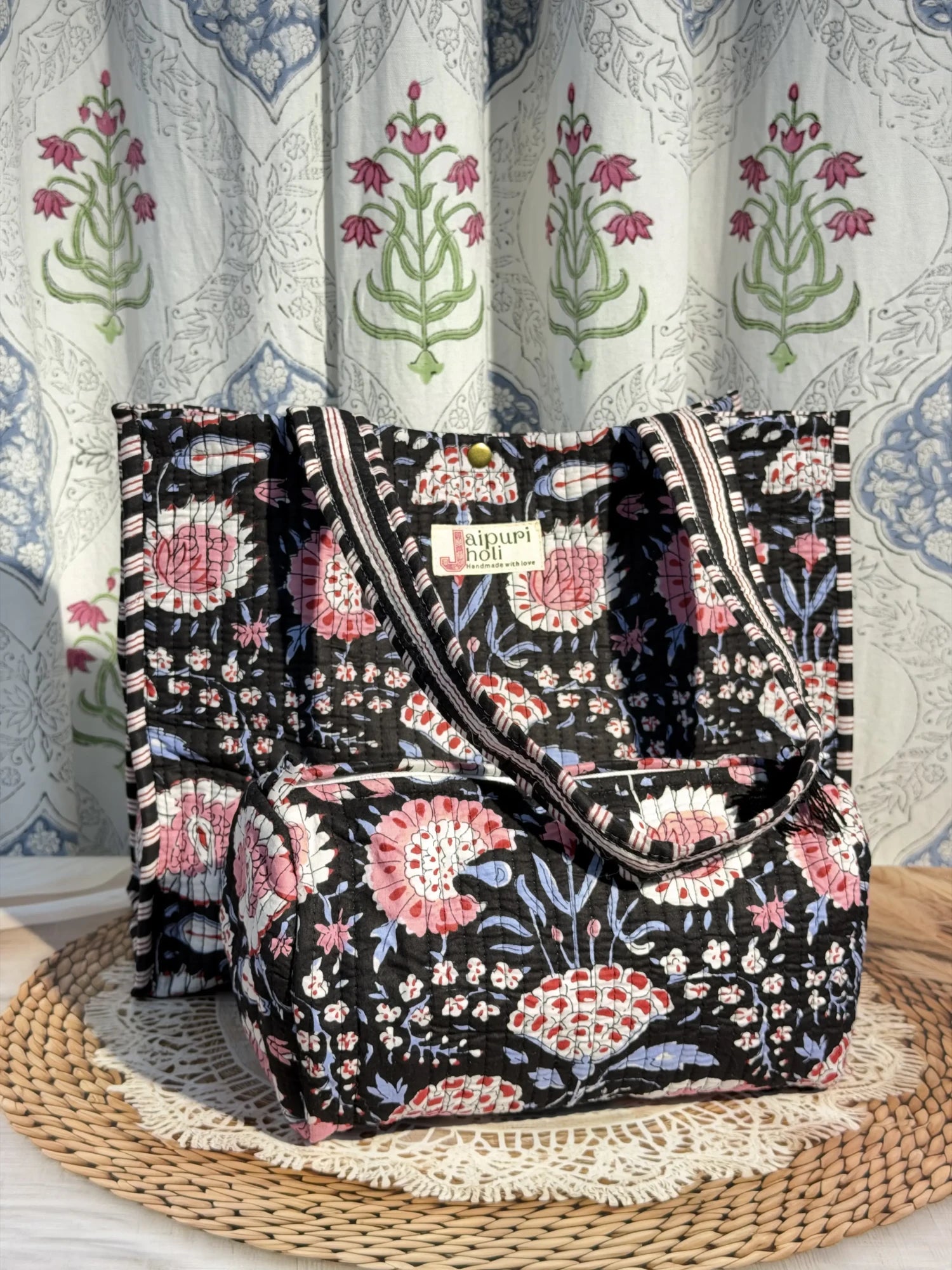 Jaipur block print cotton quilted button tote bag with matching pouch, black and pink floral print, 15×12×6 inch tote with 10×6 inch pouch for storing toiletries, cosmetics and daily essentials front view