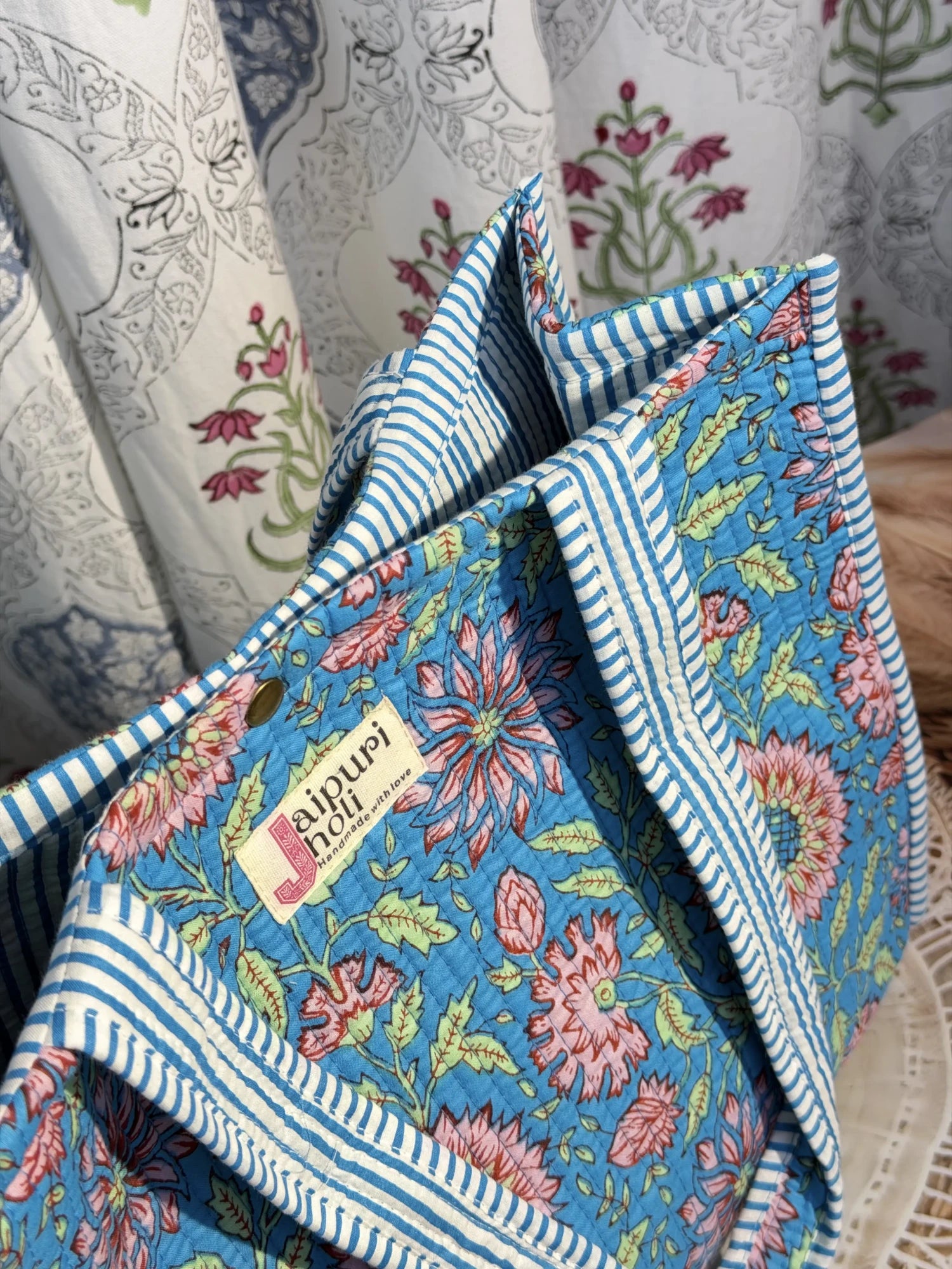 Jaipur block print cotton quilted button tote bag with matching pouch, blue floral print, 15×12×6 inch tote with 10×6 inch pouch for organizing toiletries, cosmetics and travel essentials side view