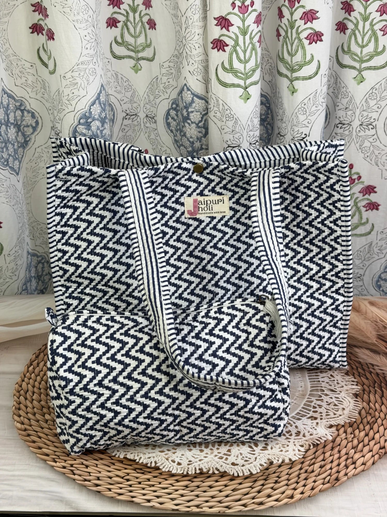 Jaipur block print cotton quilted button tote bag with matching pouch, blue and white geometric zigzag print, 15×12×6 inch tote with 10×6 inch pouch for organizing toiletries, cosmetics and travel essentials back view