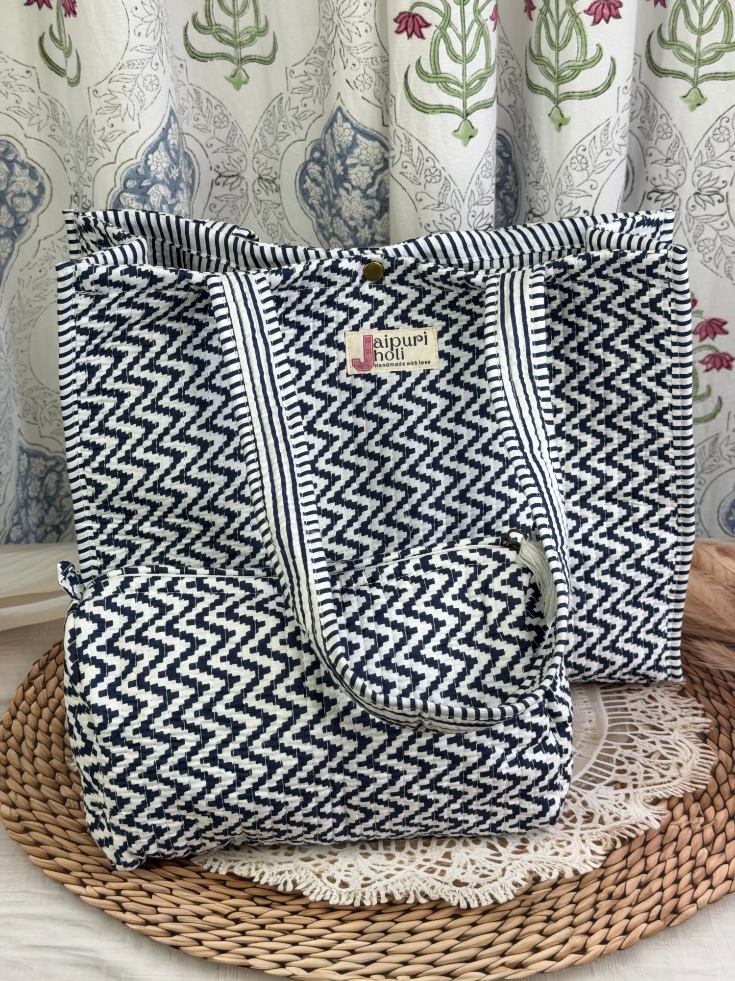 Jaipur block print cotton quilted button tote bag with matching pouch, blue and white geometric zigzag print, 15×12×6 inch tote with 10×6 inch pouch for organizing toiletries, cosmetics and travel essentials front view