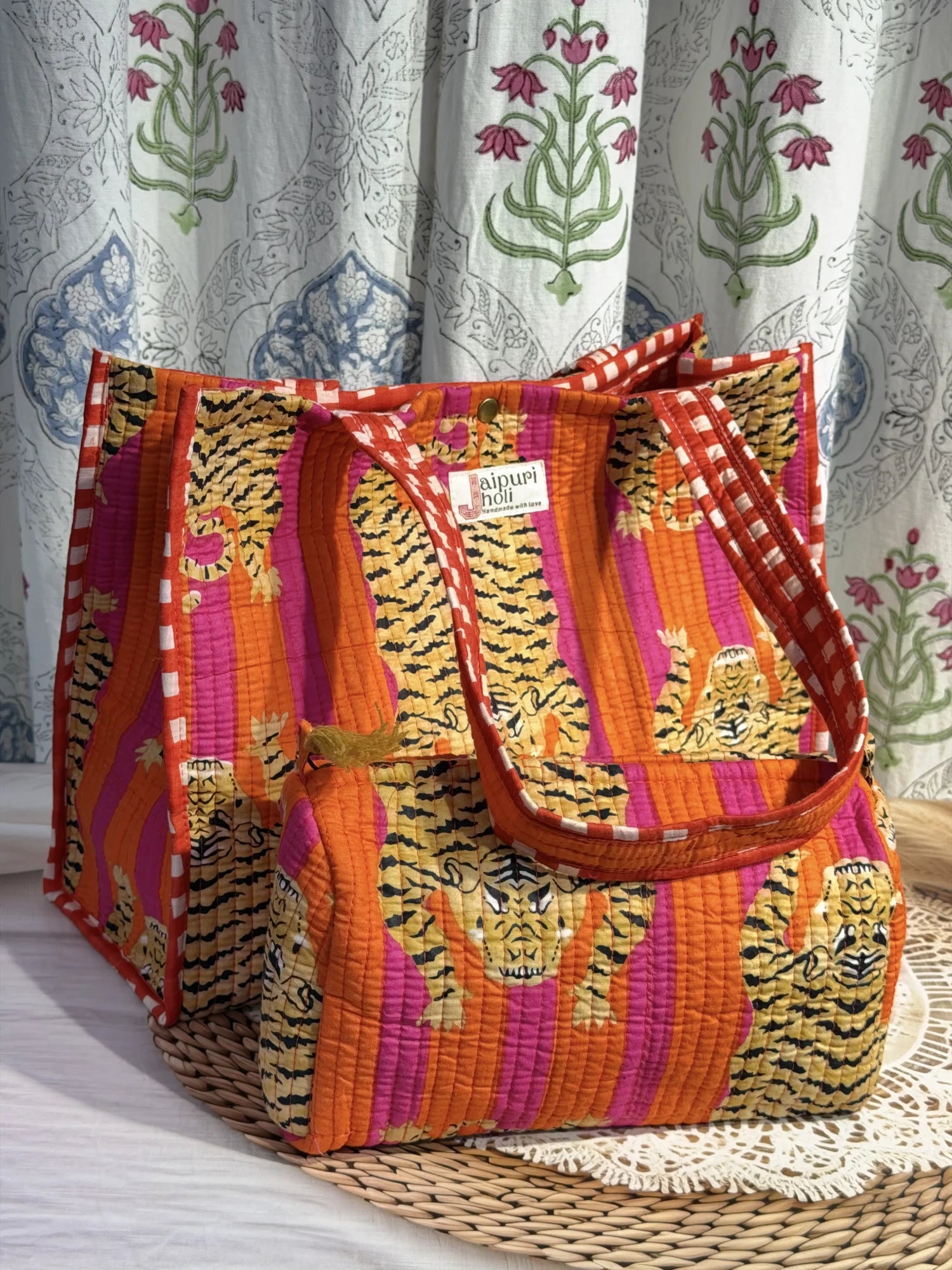Jaipur block print cotton quilted button tote bag with matching pouch, orange and pink tiger animal print, 15×12×6 inch tote with 10×6 inch pouch for storing toiletries, cosmetics and medicines close-up view