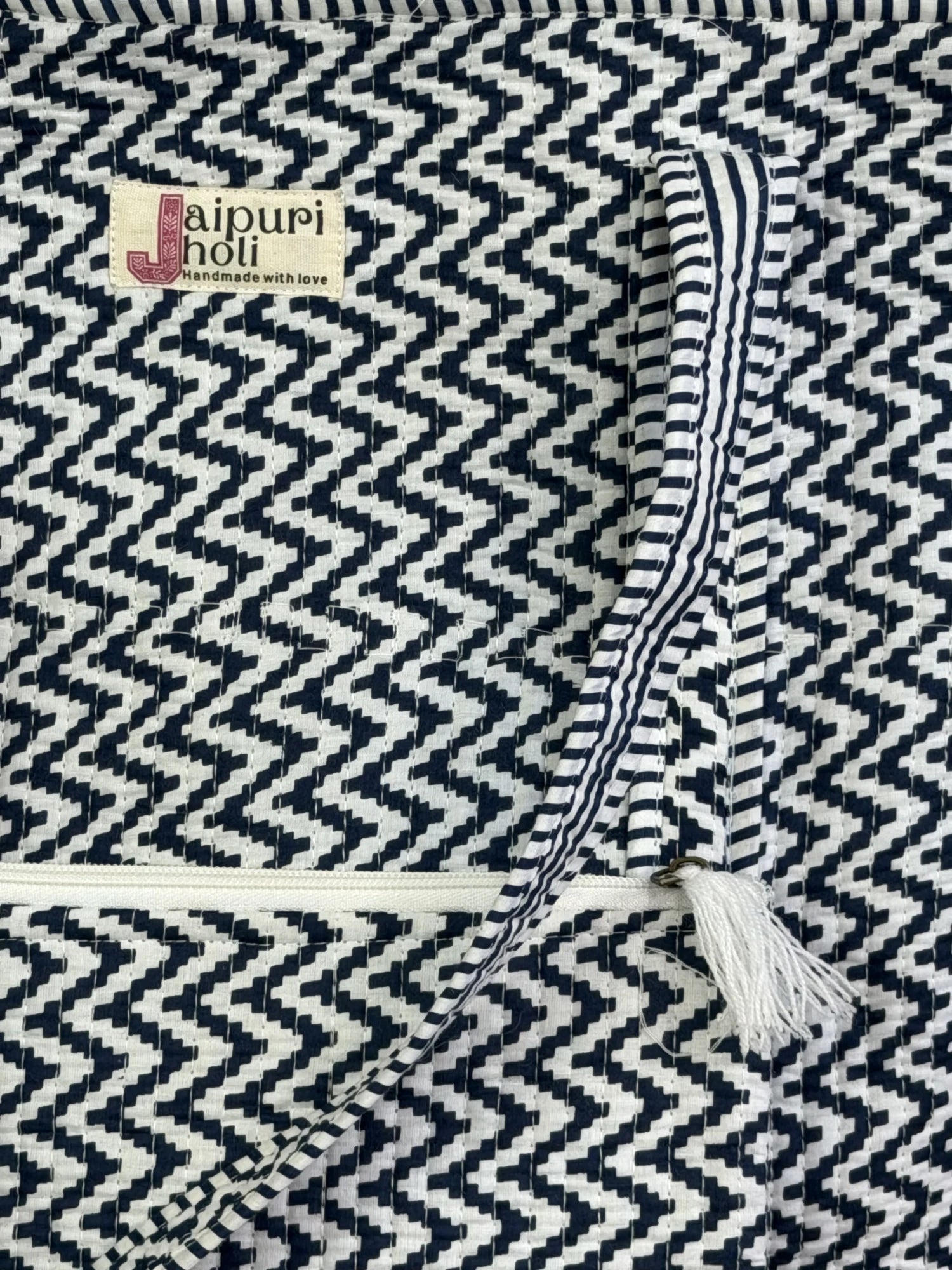 Jaipur block print cotton quilted large tote bag with matching flat pouch, blue and white geometric zigzag print, 18×18×6 inch tote with 9×7 inch flat pouch for documents, chargers and travel essentials close-up view